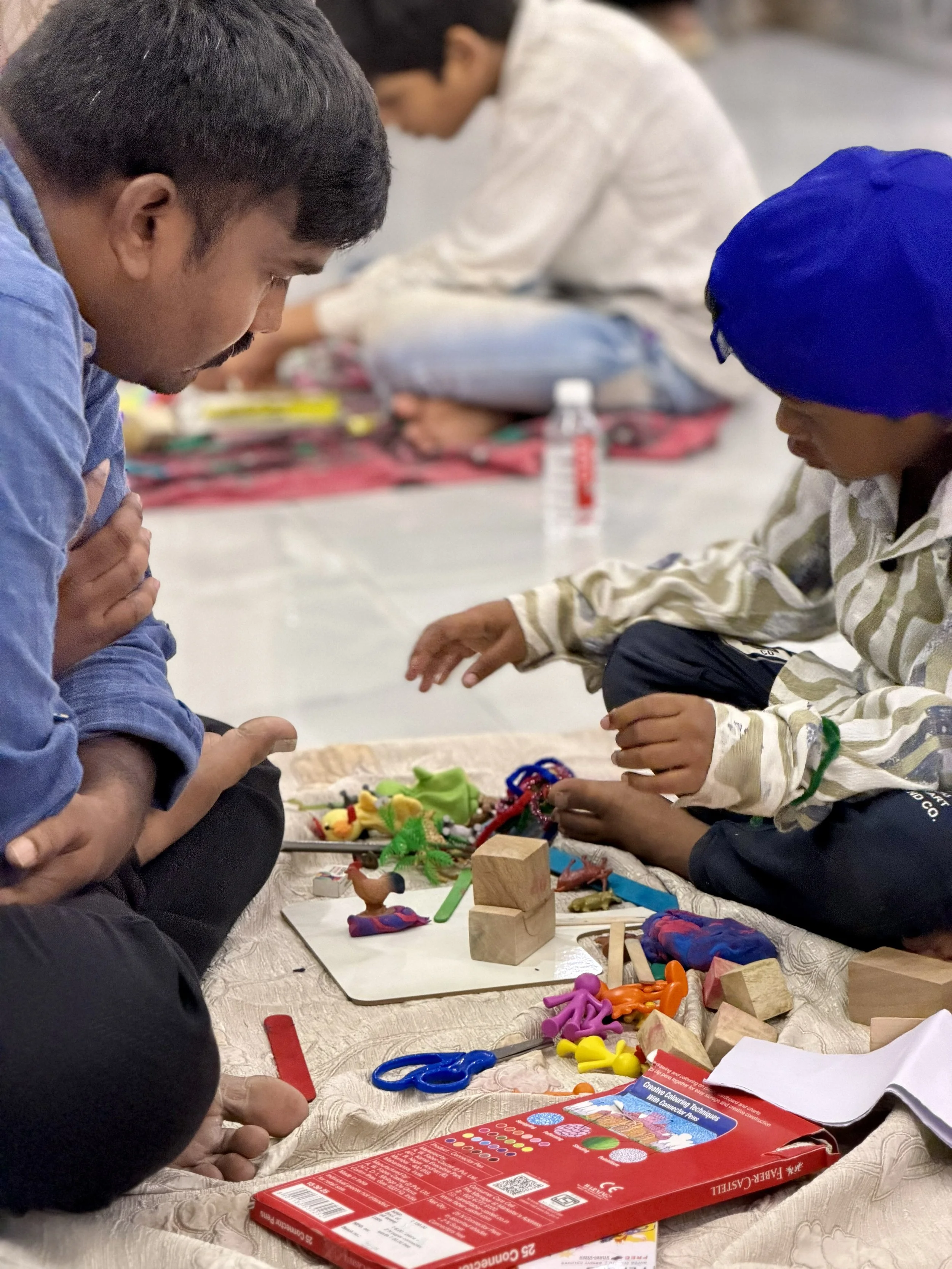 A Jacaranda Communities of hope leader facilitating activities with a child in the programme.