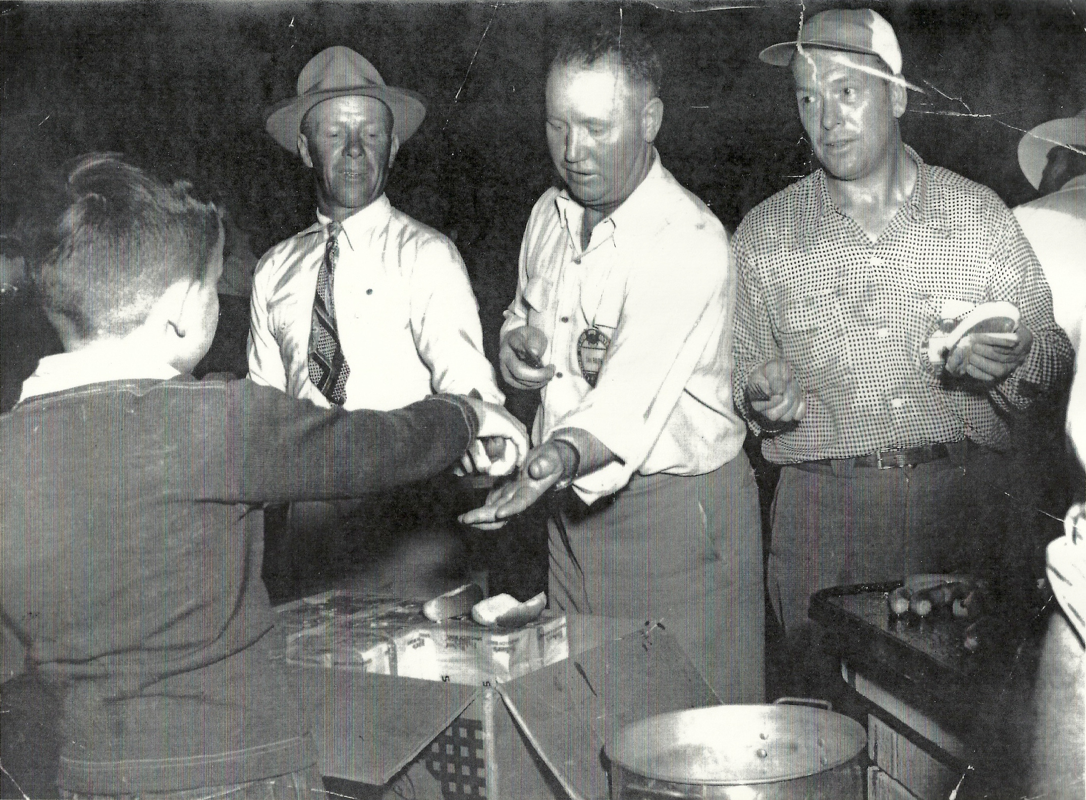  Boy serving hot dogs at an unknown event. 