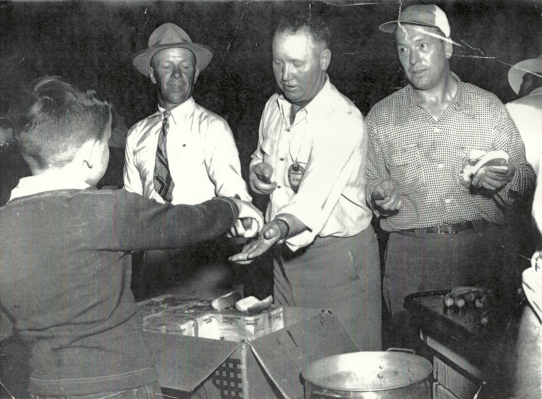 Boy serving hot dogs at an unknown event.