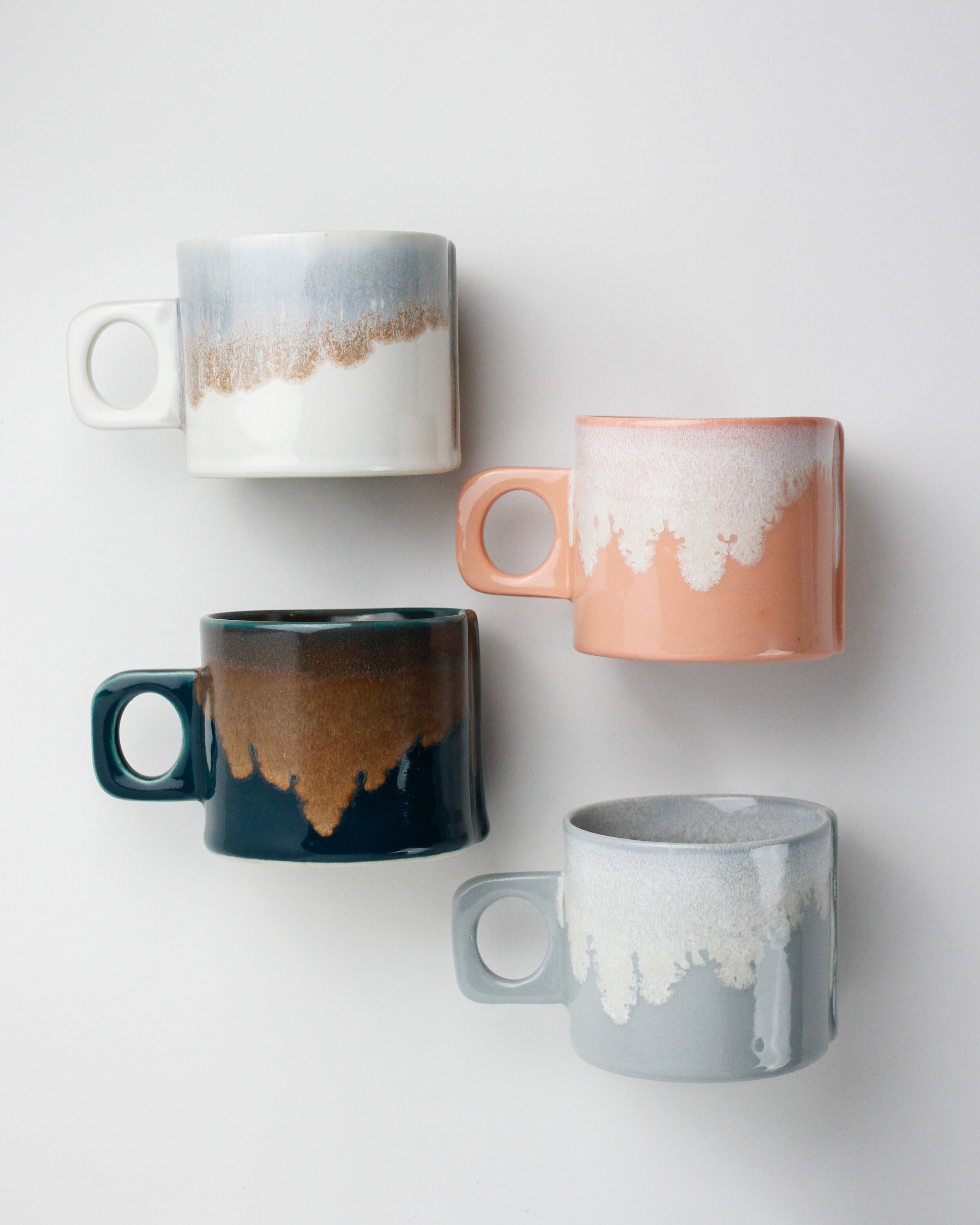 three small 8 oz ceramic coffee mugs