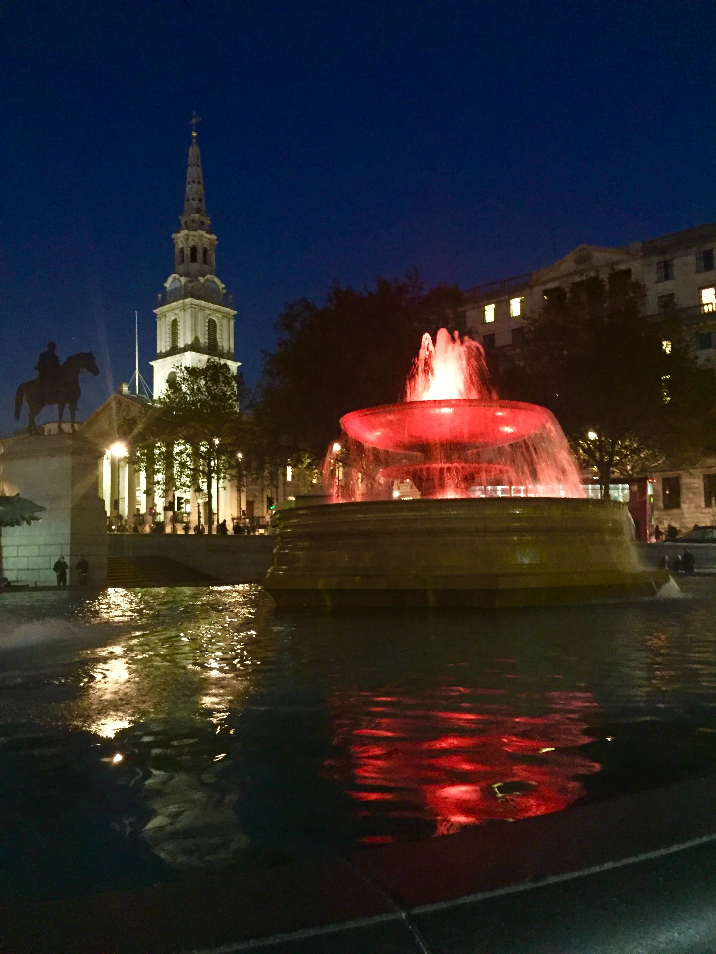 Trafalgar Square fountains in London lit orange for Color The World Orange™ 2016
