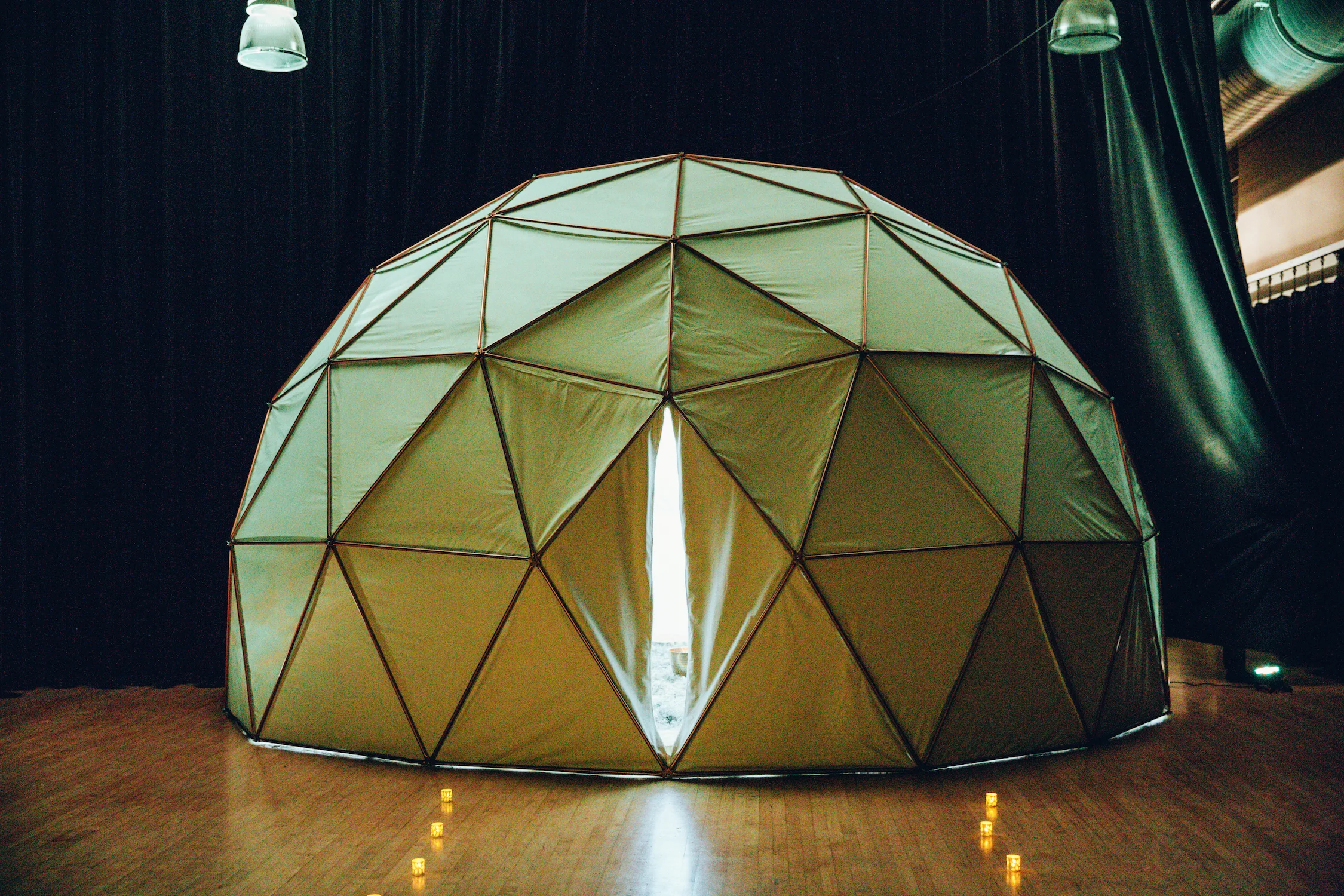 The Death Dome is a fully immersive audio/visual experience inspired by the Bardos - the intermediary stages between life, death and reincarnation. The Interior utilizes projection mapping with original hand made animations and a surround sound musicscape. Users participate in a writing reflection, grounding exercise and a symbolic ritual to release patterns and emotions.