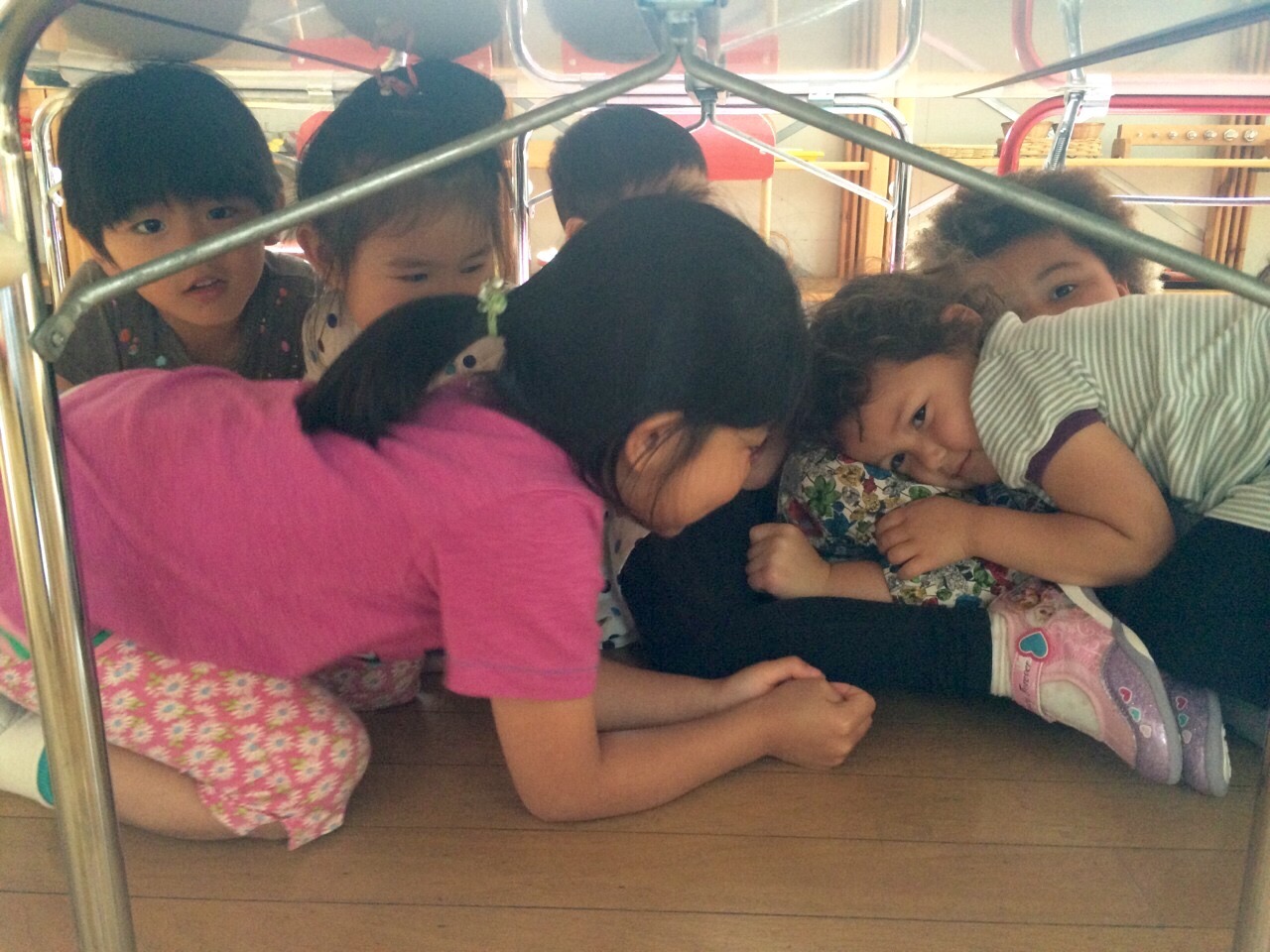 Children practicing going under the table.