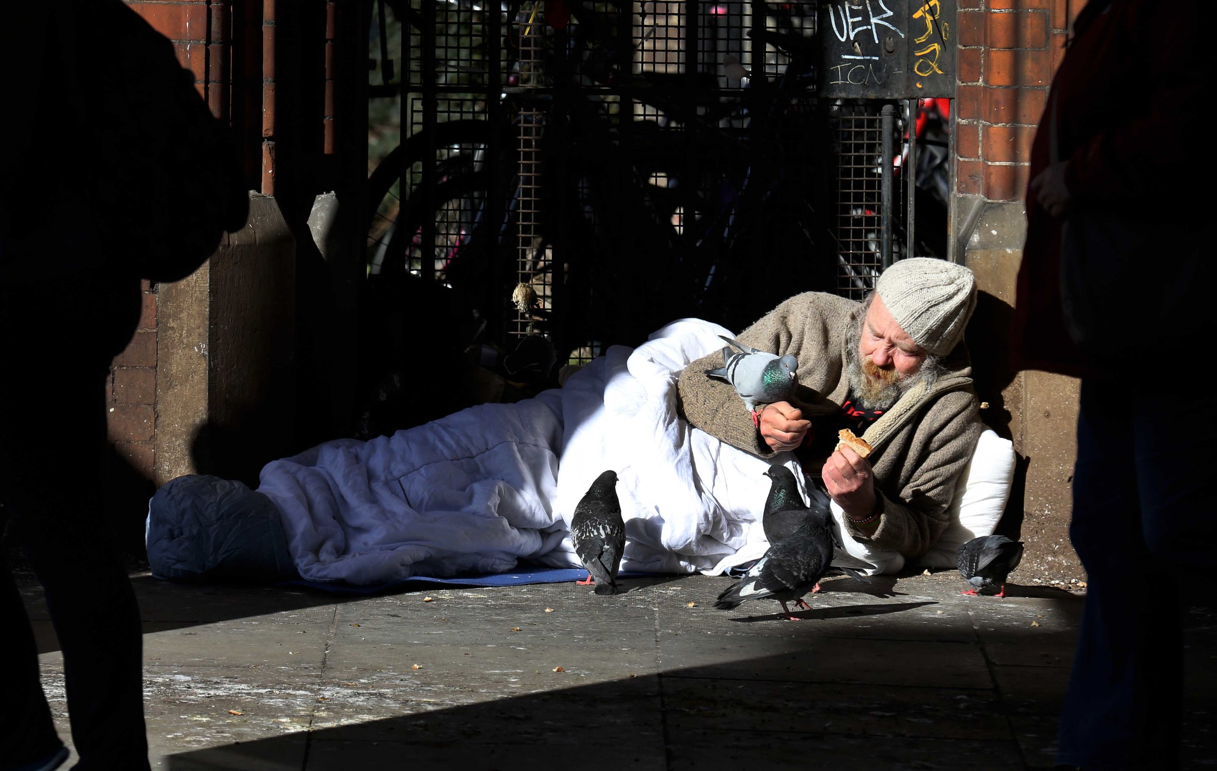 Martin Hart feeds pigeons from his sleeping bag on Westland Row