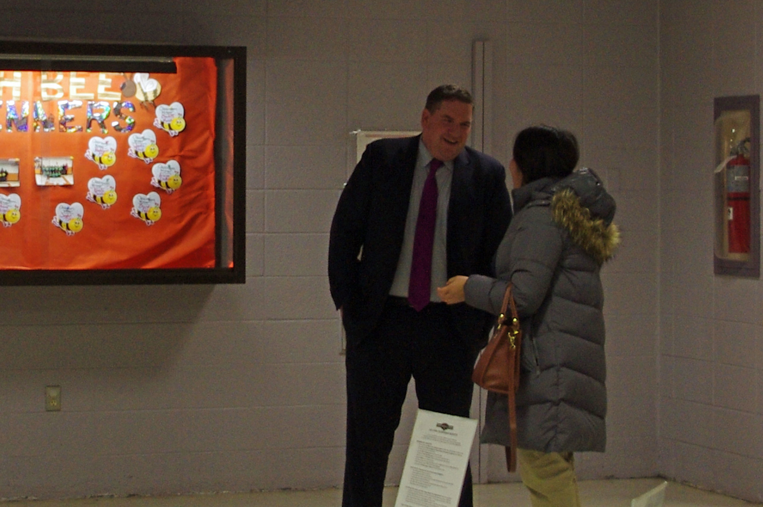 Principal Bill Black of West Broadway Middle School catches up with a neighbor