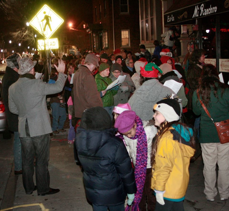  Conductor Glenn Zienowicz leads carolers down Westminster Street (2013)  Photo Credit: Elaine Collins  