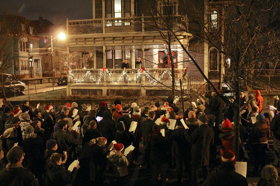  Carolers find an audience on a pretty porch on Messer Street (2014)  Photo Credit: Elaine Collins  