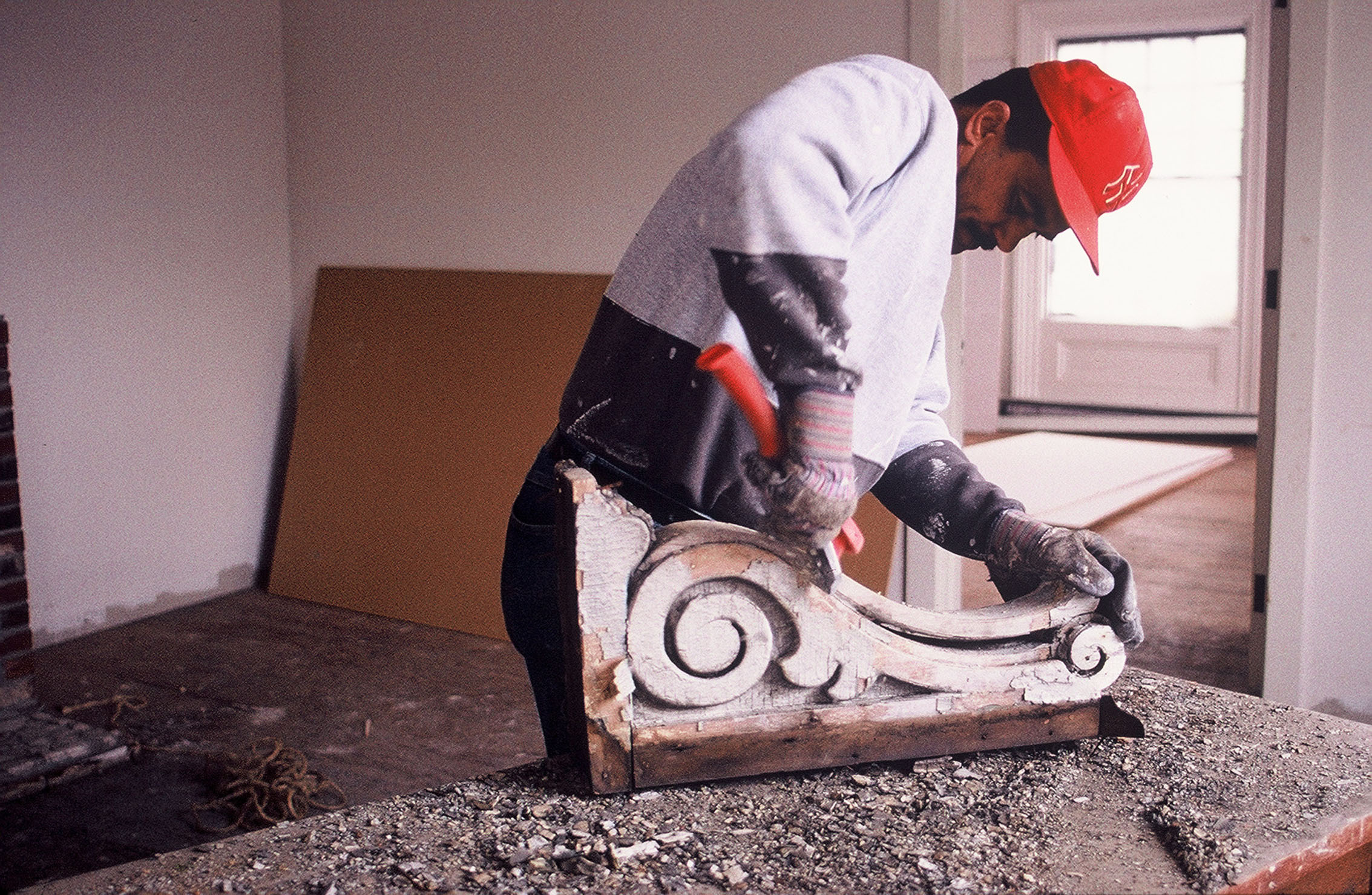  Restoring one of many elaborate cornice brackets,&nbsp;2002  Photo credit: Clark Schoettle, Providence Revolving Fund  