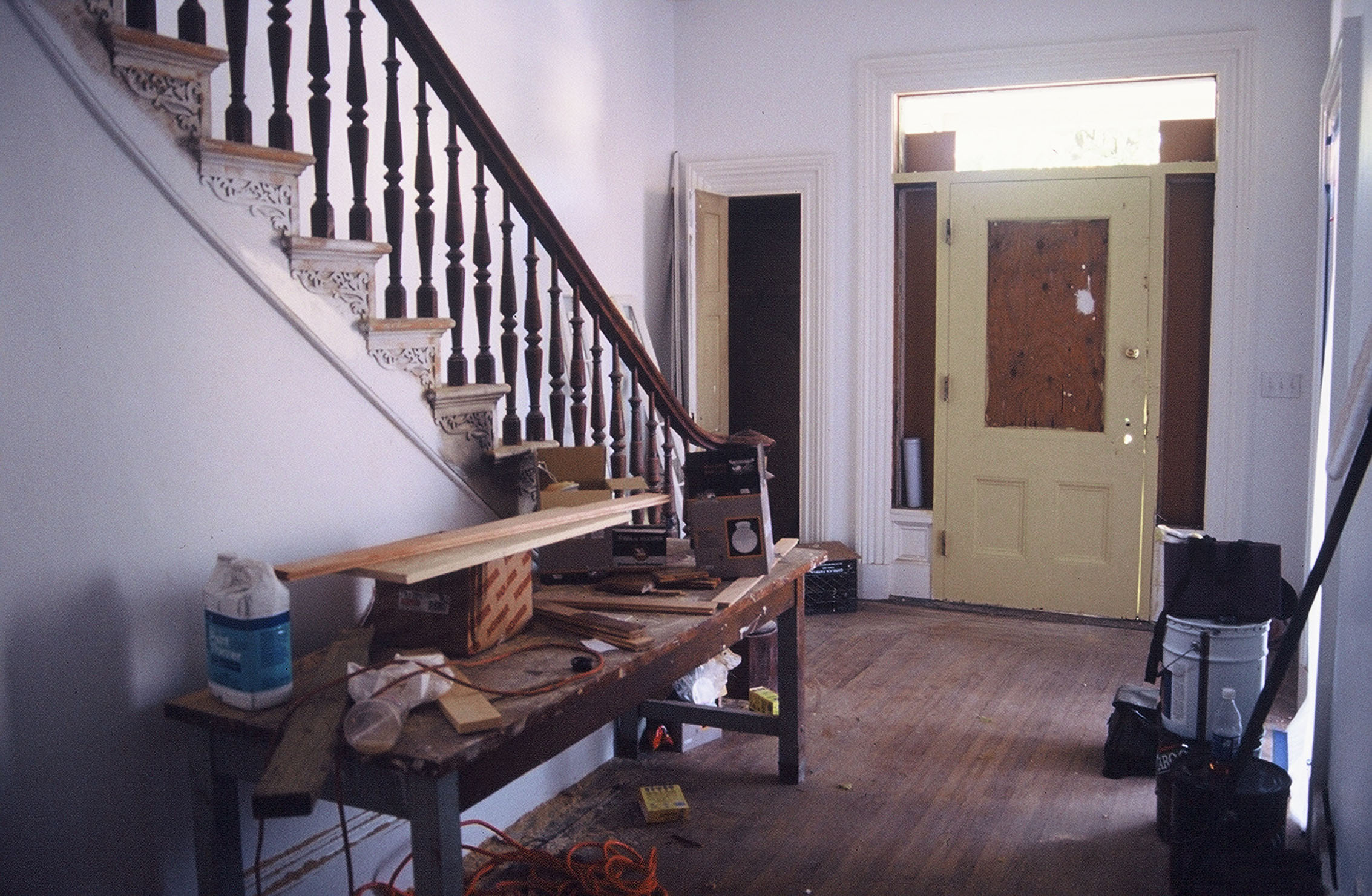  Front entry and hall, 2002 –&nbsp;original transom and side light windows had been replaced with glass blocks  Photo credit: Clark Schoettle, Providence Revolving Fund  