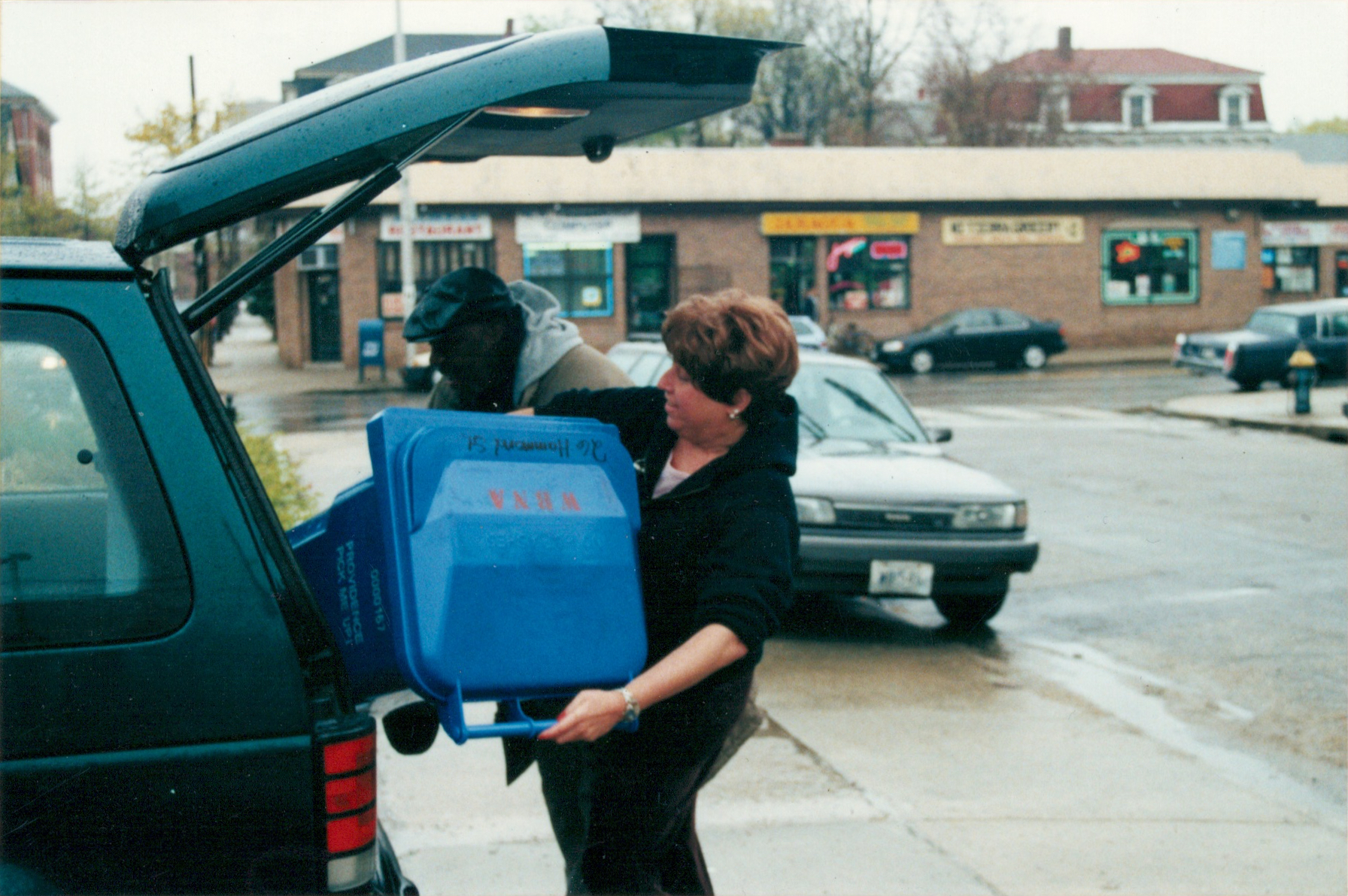  Neighbor-organizer Karen Ziner helps a neighbor on Hammond Street load up (2000) 