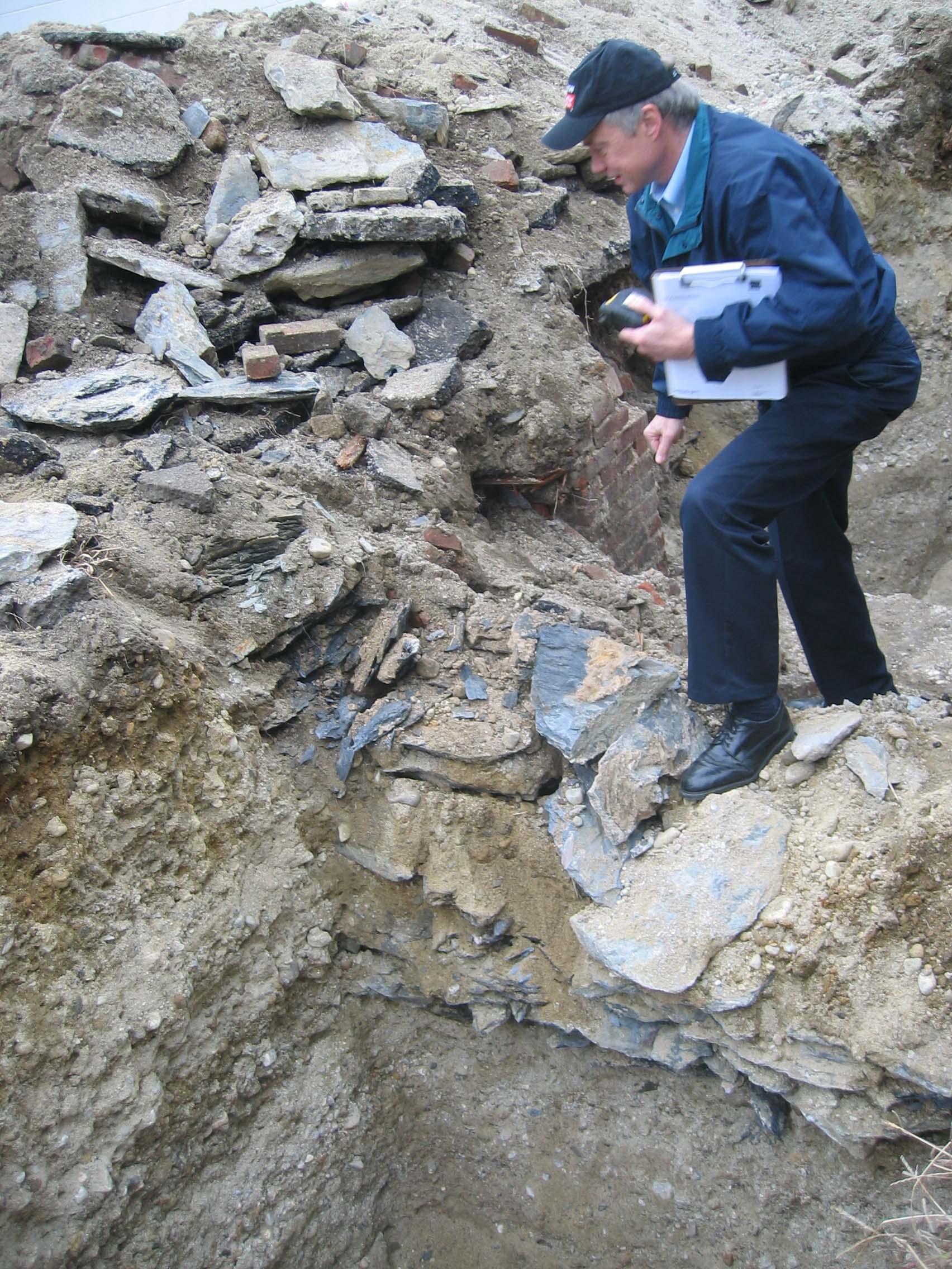 Peter Grafe checking out excavated slate and brick foundations from a Victorian homestead that once stood at 1577. A piece of copper from the original home was also found.  Photo courtesy of KITE Architects  
