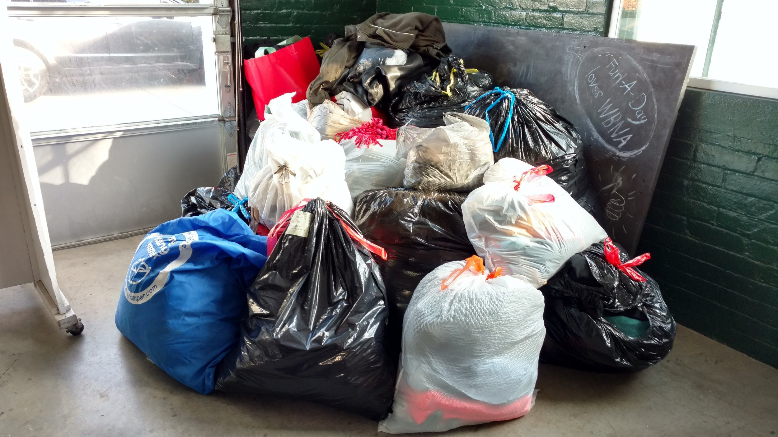  Nearly 25 full trash bags collected of coats, gloves, hats and scarves 