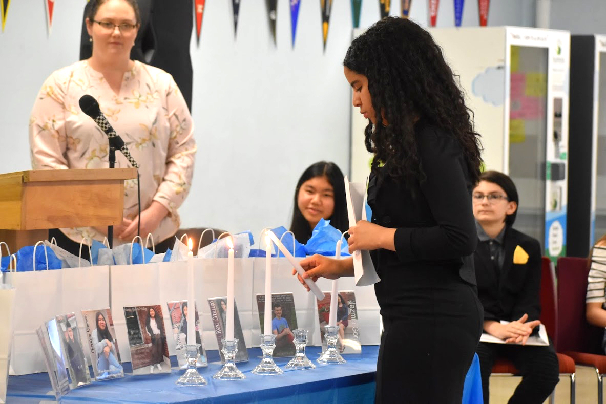  A new NJHS member lights a candle as part of the ceremony 
