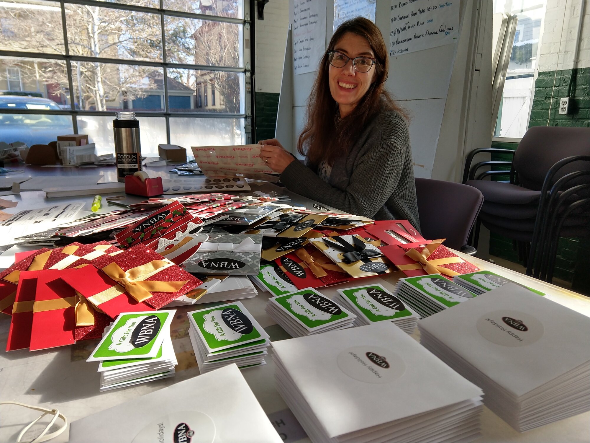  Executive Director Kari Lang prepares gift card donations for drop-offs to neighborhood nonprofits 