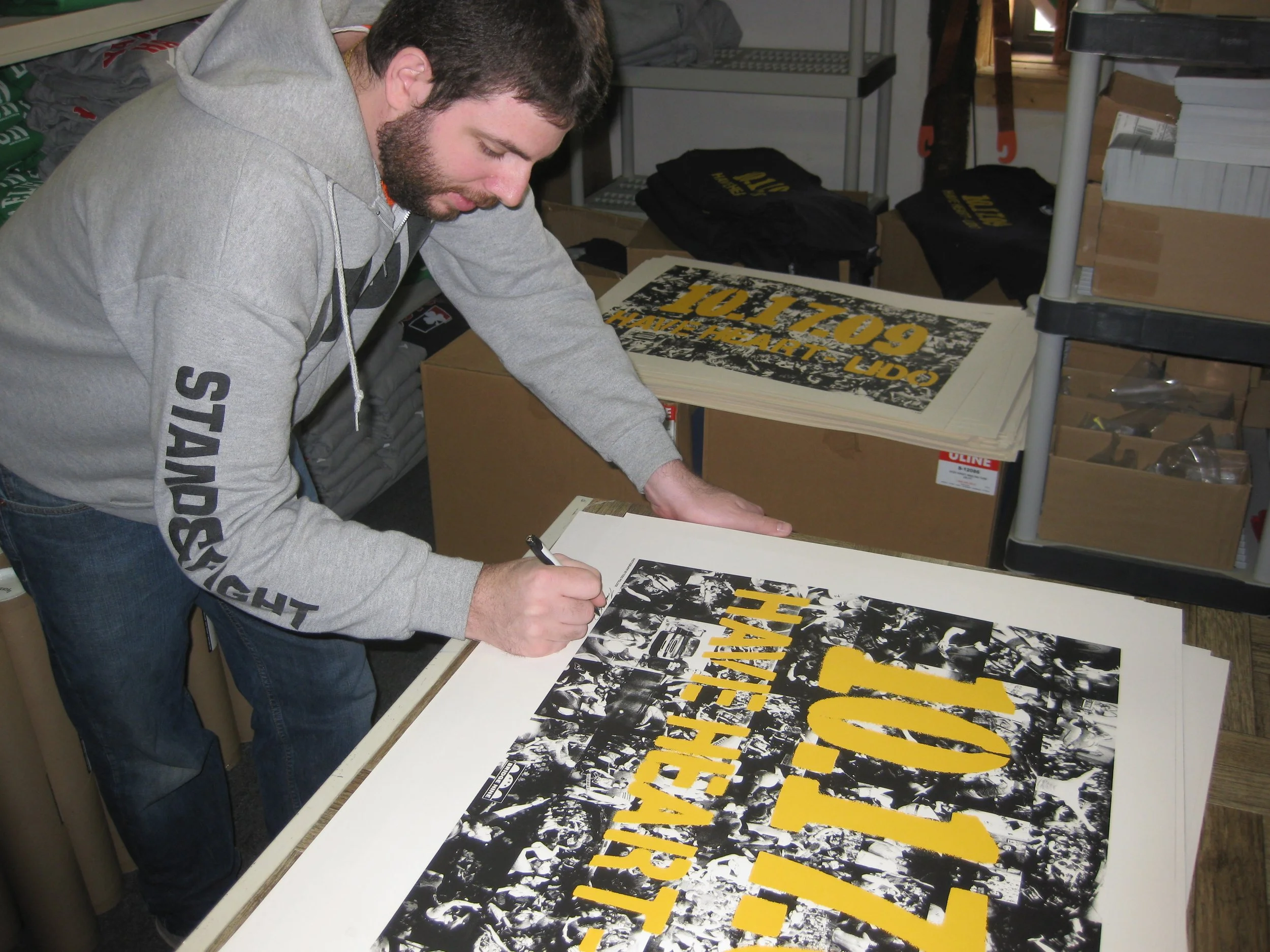 Photographer Todd Pollock signing a Have Heart "Stencil" 10.17.09 print with the same design as the T-shirt