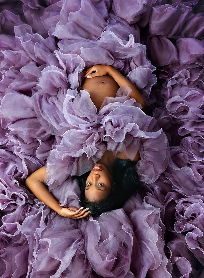 Maternity portrait in purple ruffled dress, luxury fine art photographer serving Rice Village and West University.