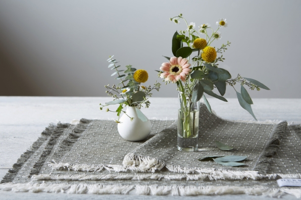 Photo by Jennifer Marx. From the cut remnants of blankets, table linens and pillows are made. These are the new placemats which can be purchased here .