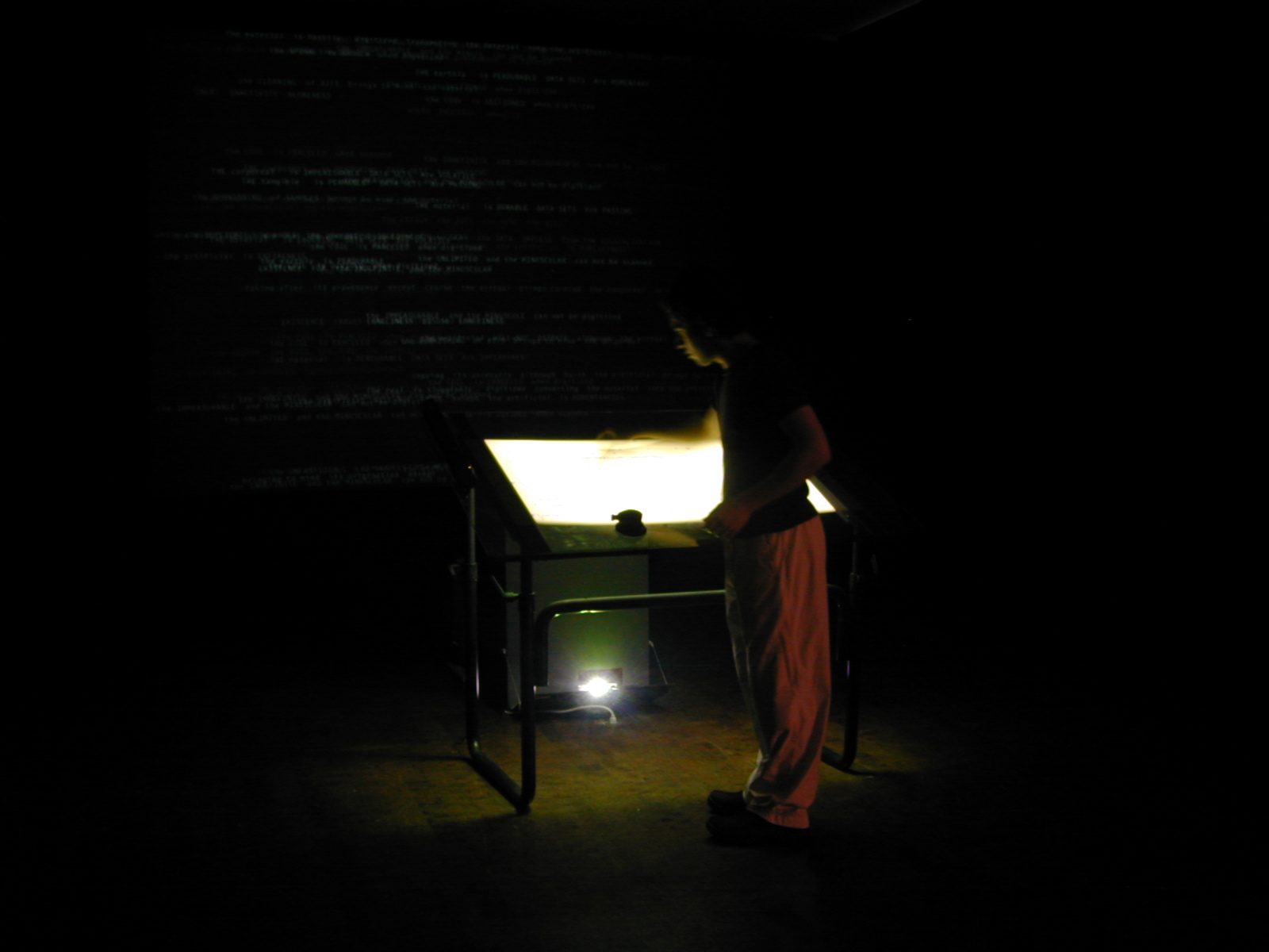 Participants are invited to draw with dry-erase marker on the surface of a glass drafting table. Displayed on the table is a soup of letters, which are repelled (like magnets) from the maker, the eraser, and from each other. When the participant draws (or erases) on the table, the letters move fluidly (as if being stirred). This movement provides the user with immediate feedback from the installation.