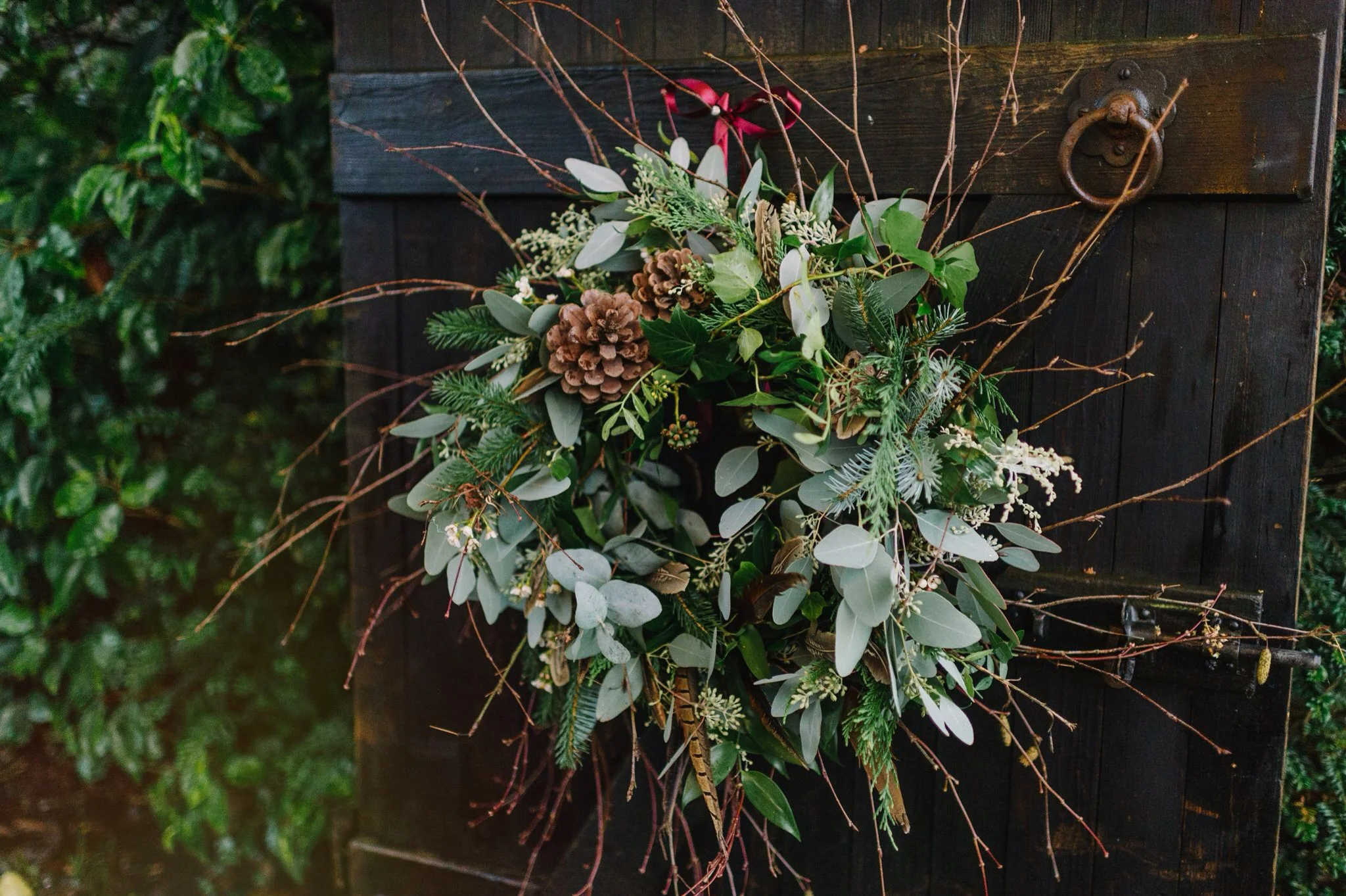 Rustic wreath with mixed foliages, dried Lotus heads, twigs, pine cones, Waxflower and Pheasant feathers. 
