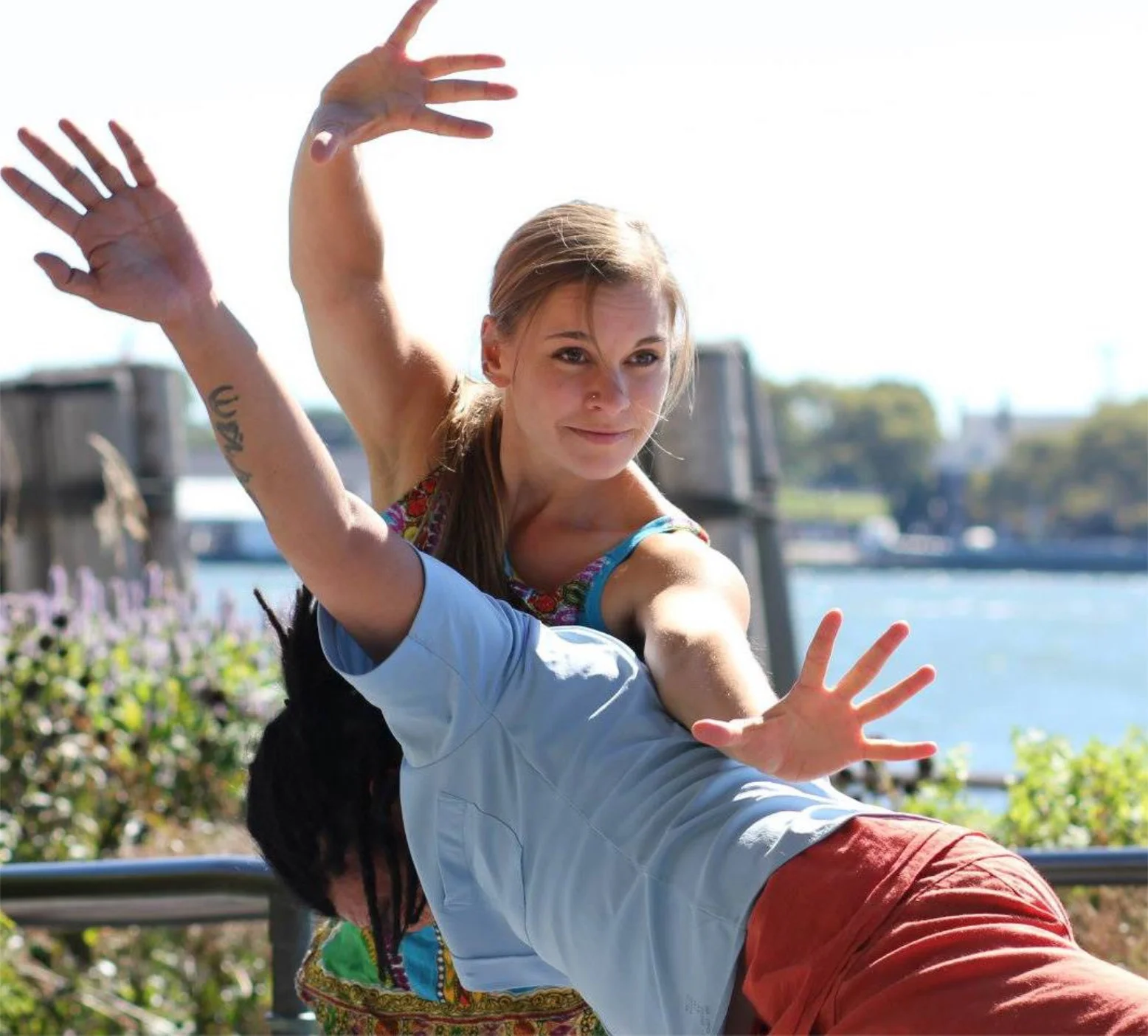 Reaching over Benny's shoulder in Battery Park.jpeg