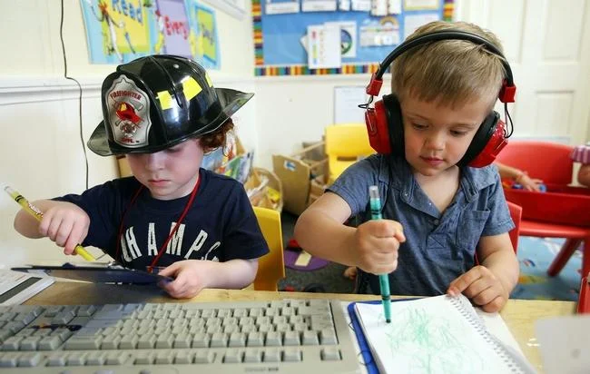 Two students at the Neighborhood Cooperative Nursery School in Winchester try out their drawing skills May 11. Wicked Local Staff Photo/Ann Ringwood