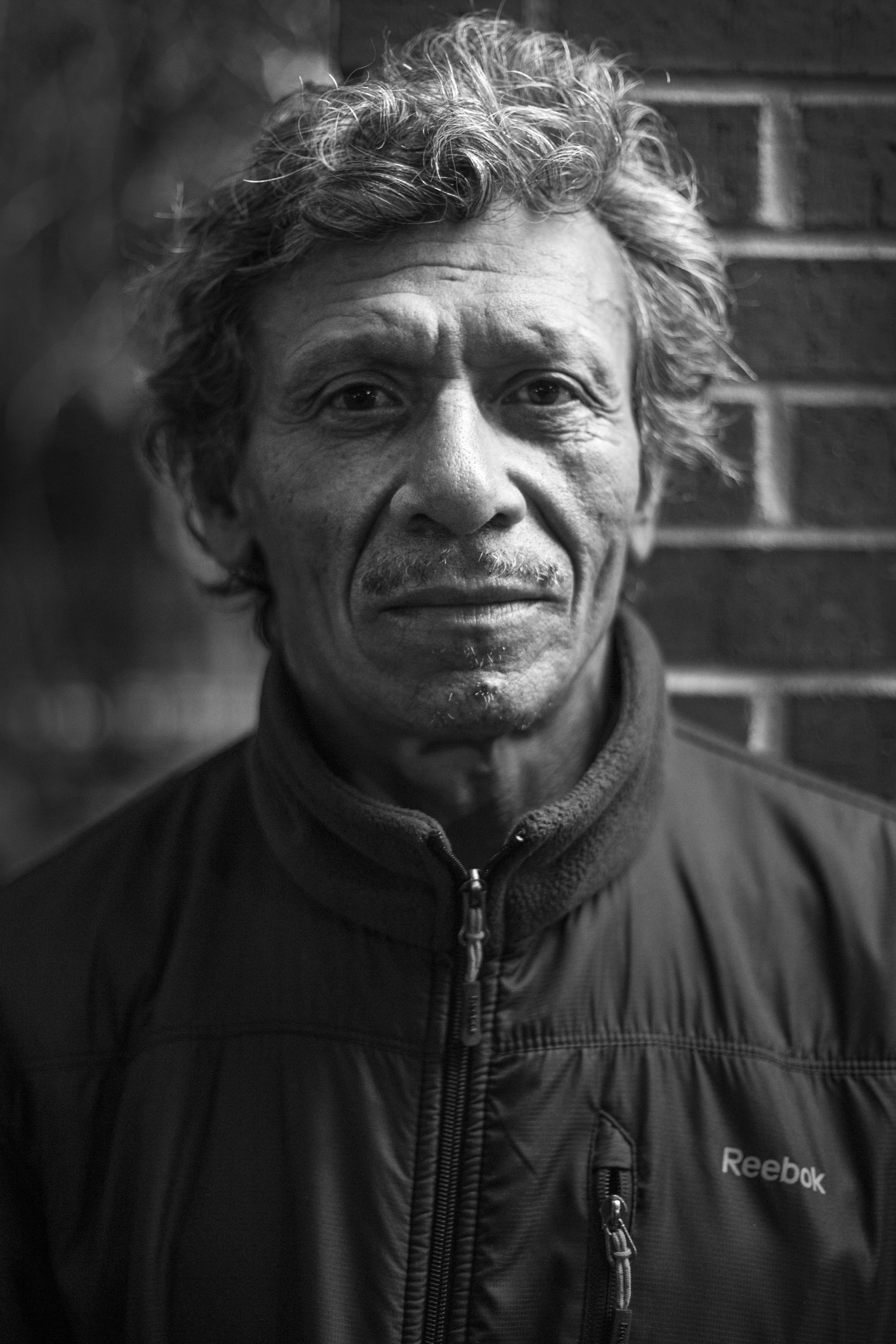 On the weekends, José joins a group of friends playing checkers with a makeshift board outside a 7-11 market in the Mt. Pleasant neighborhood of Washington, D.C. Today was cold with flurries of snow, but that didn't stop them from playing. José came to D.C. from El Salvador in 1991 for a better paying job. He is now 54 and works in construction.