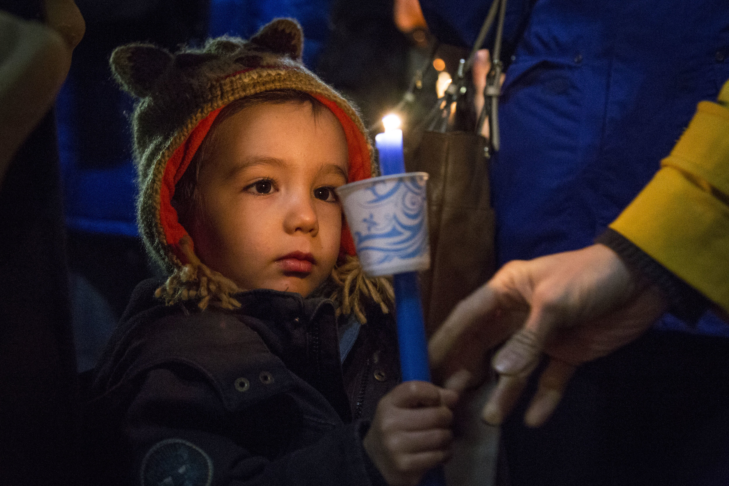  WASHINGTON, D.C. A young boy grasps a candle during a vigil for the Paris terrorist attack in 2015. 
