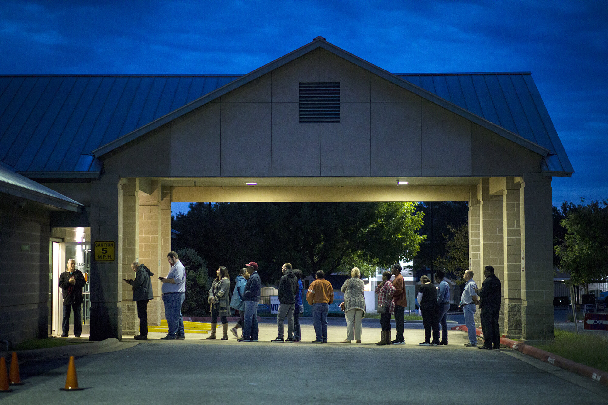  AUSTIN, TX. Voters gather outside of the Travis County Tax Office before sunrise to vote on the first day of early voting for the 2018 midterm election.  