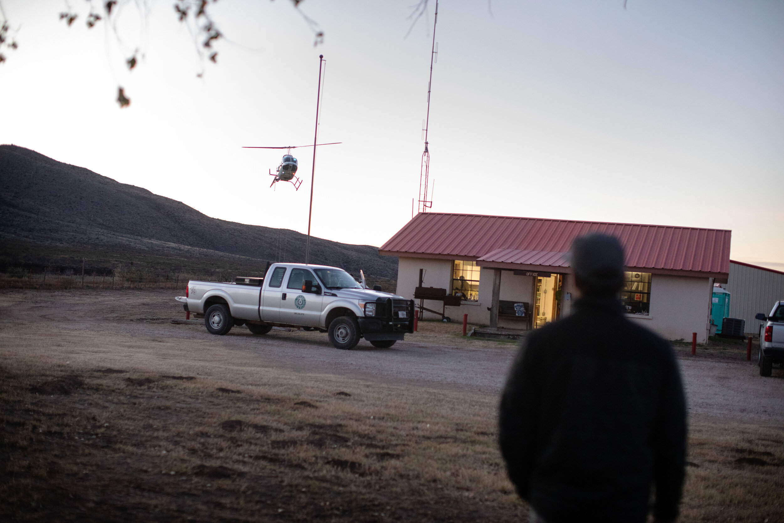  A helicopter flies over Elephant Mountain as the sun rises for the first round of sheep captures for the day. The Texas Parks and Wildlife Department relocate Desert Big Horn Sheep from Elephant Mountain to Black Gap Wildlife Management Area. 