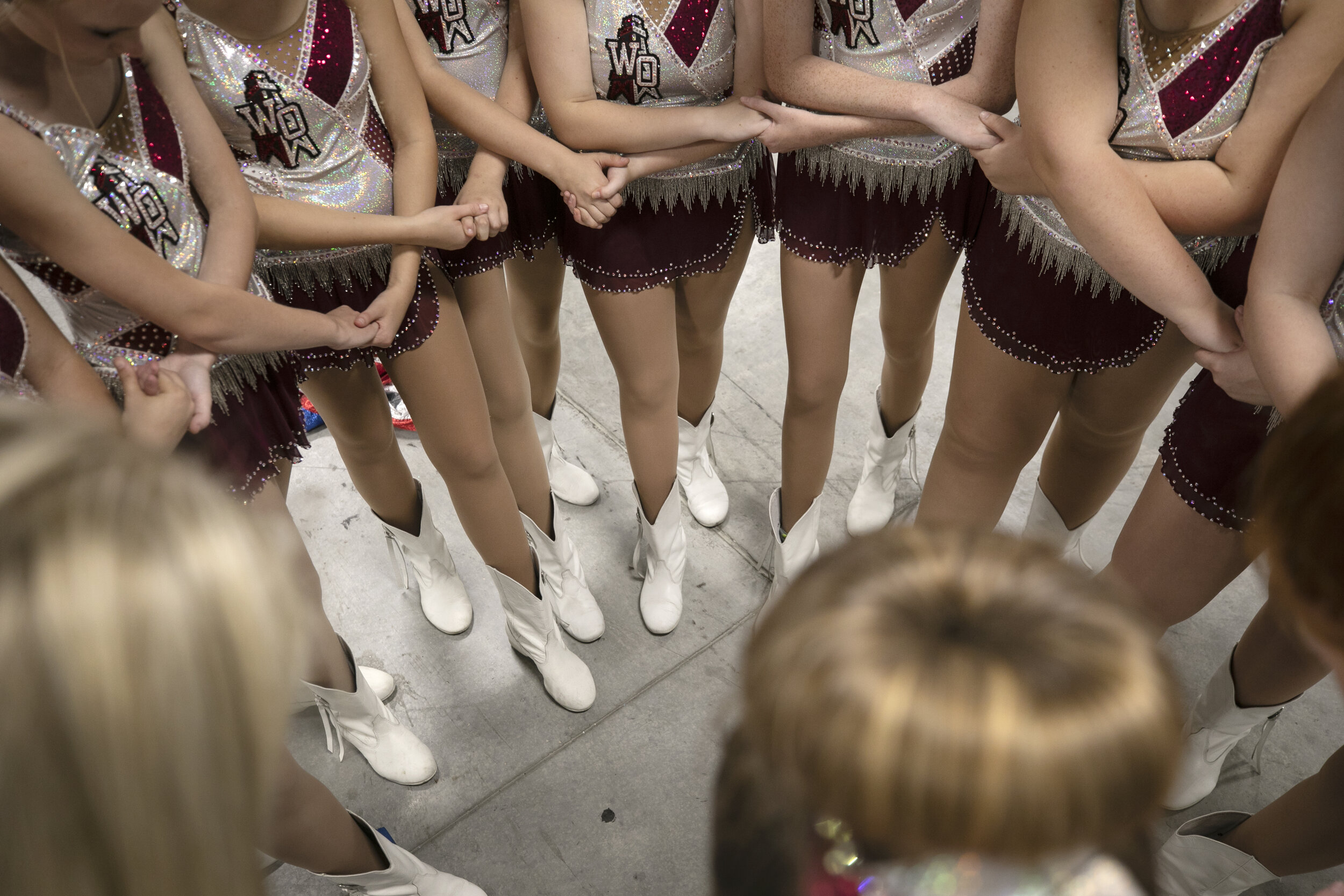  Majorettes pray together before the competition. 