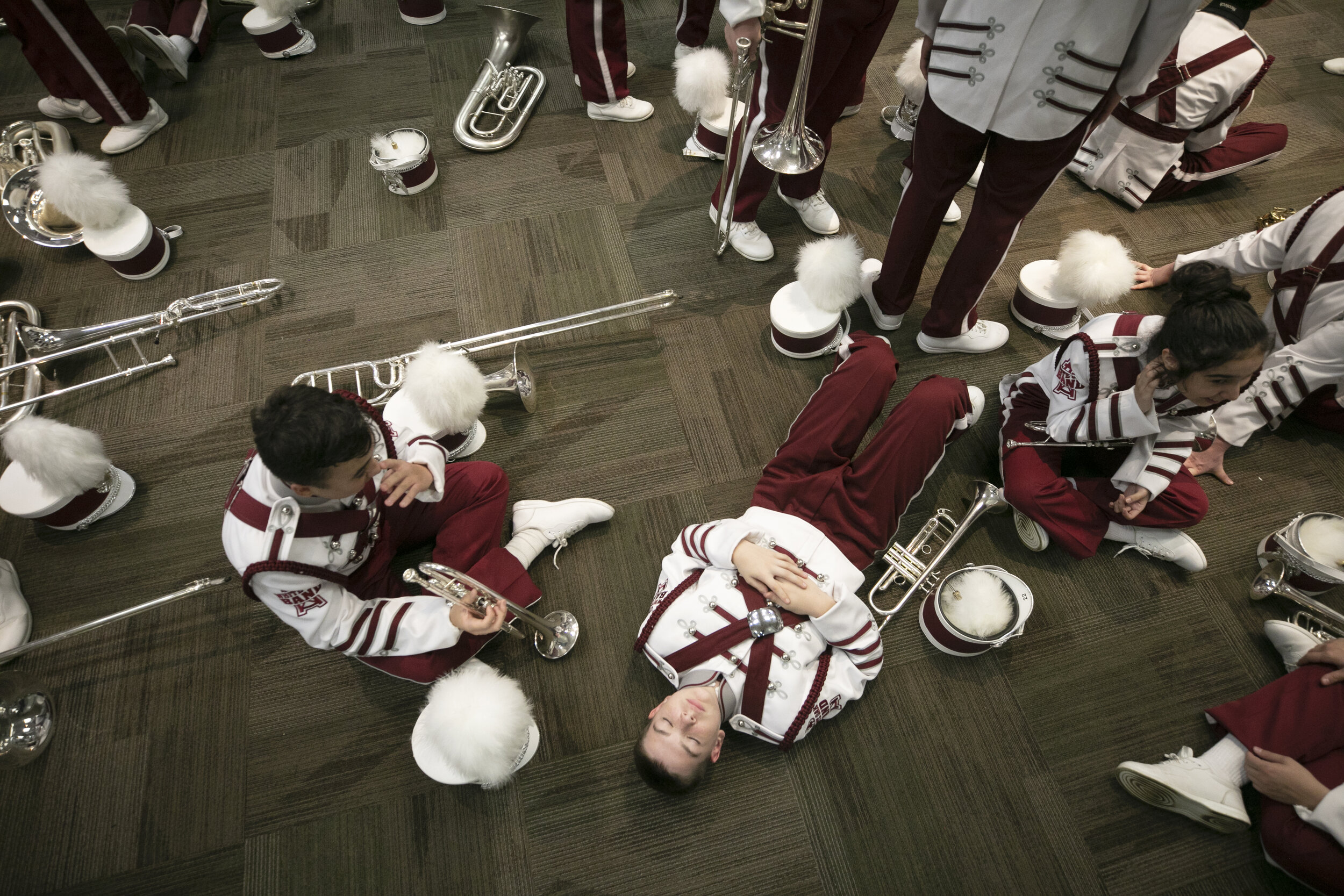  White Oak Marching Band students rest after the competition while they await results. 