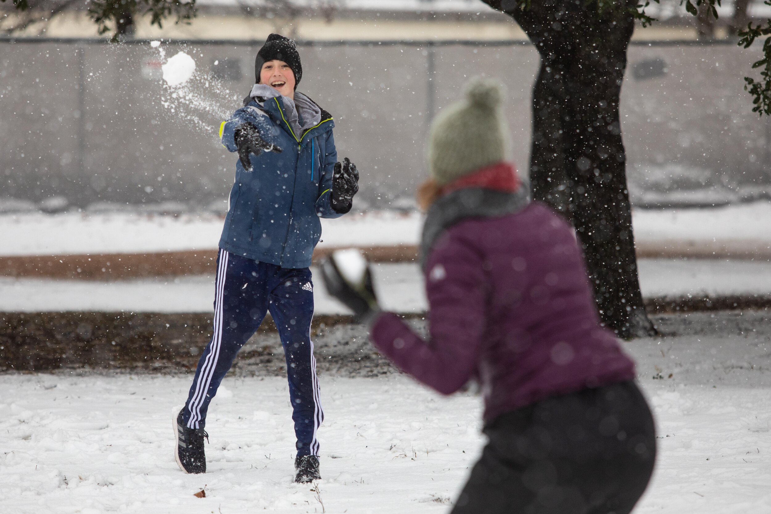  AUSTIN, TX. Jan. 10, 2021. Asher (left) throws a snowball at Rebecca Sorenson (right) during their snowball fight on a rare snow day at Brentwood Neighborhood Park.  
