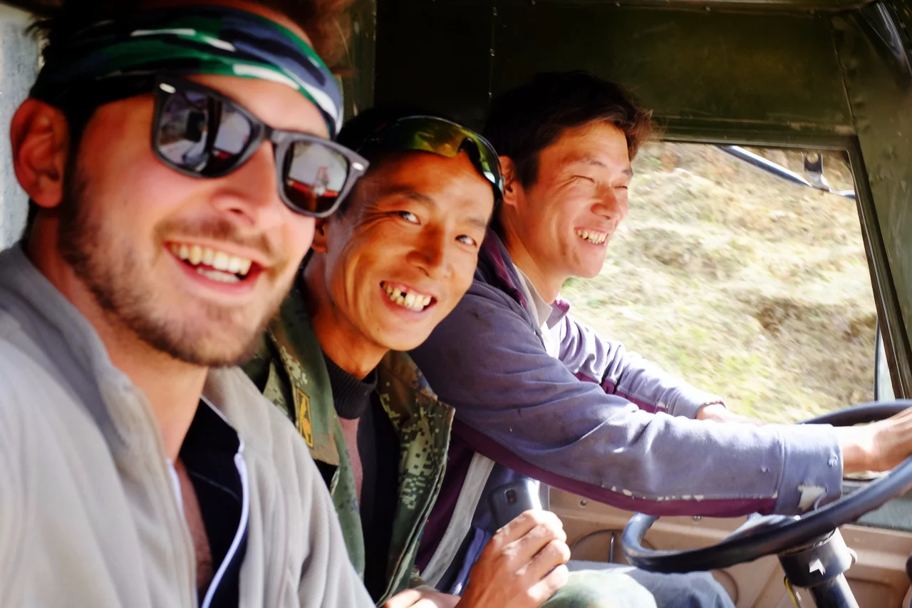 Hitching a ride with local truck drivers.