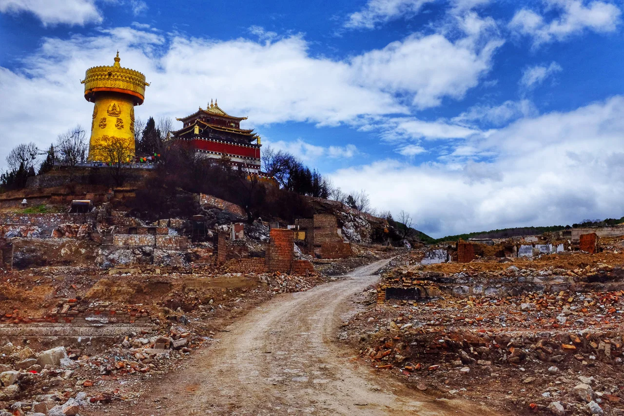 Dafo temple and its massive prayer wheel standing above the ruins of Shangri-La's old town.