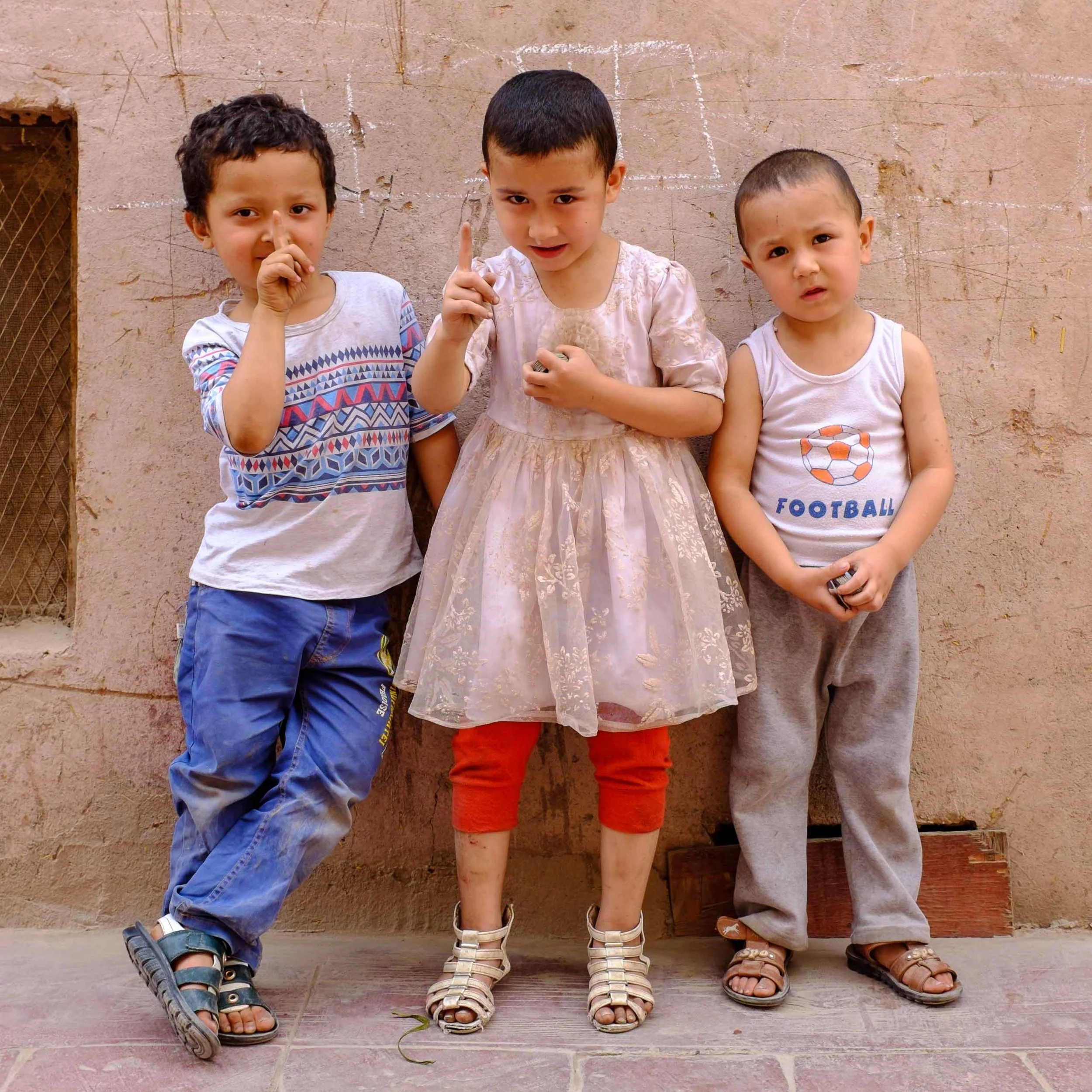 These kids were playing with Pogs in the street but leapt up to pose when they saw my camera.
