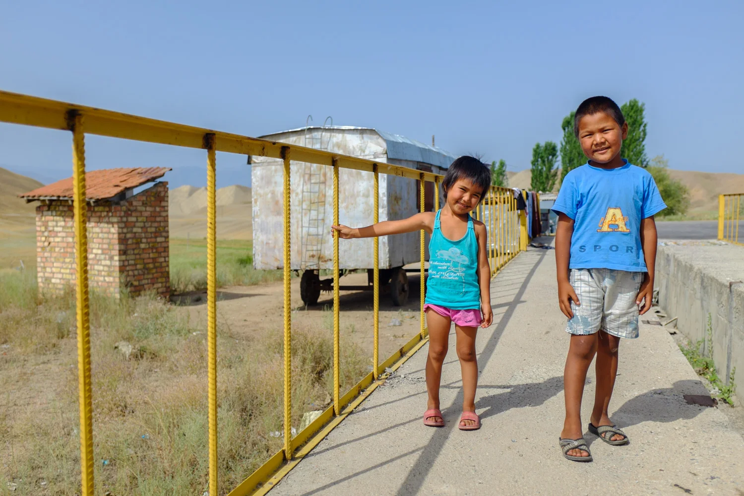 Two kids at a Kyrgyz truck stop near Toktogul lake