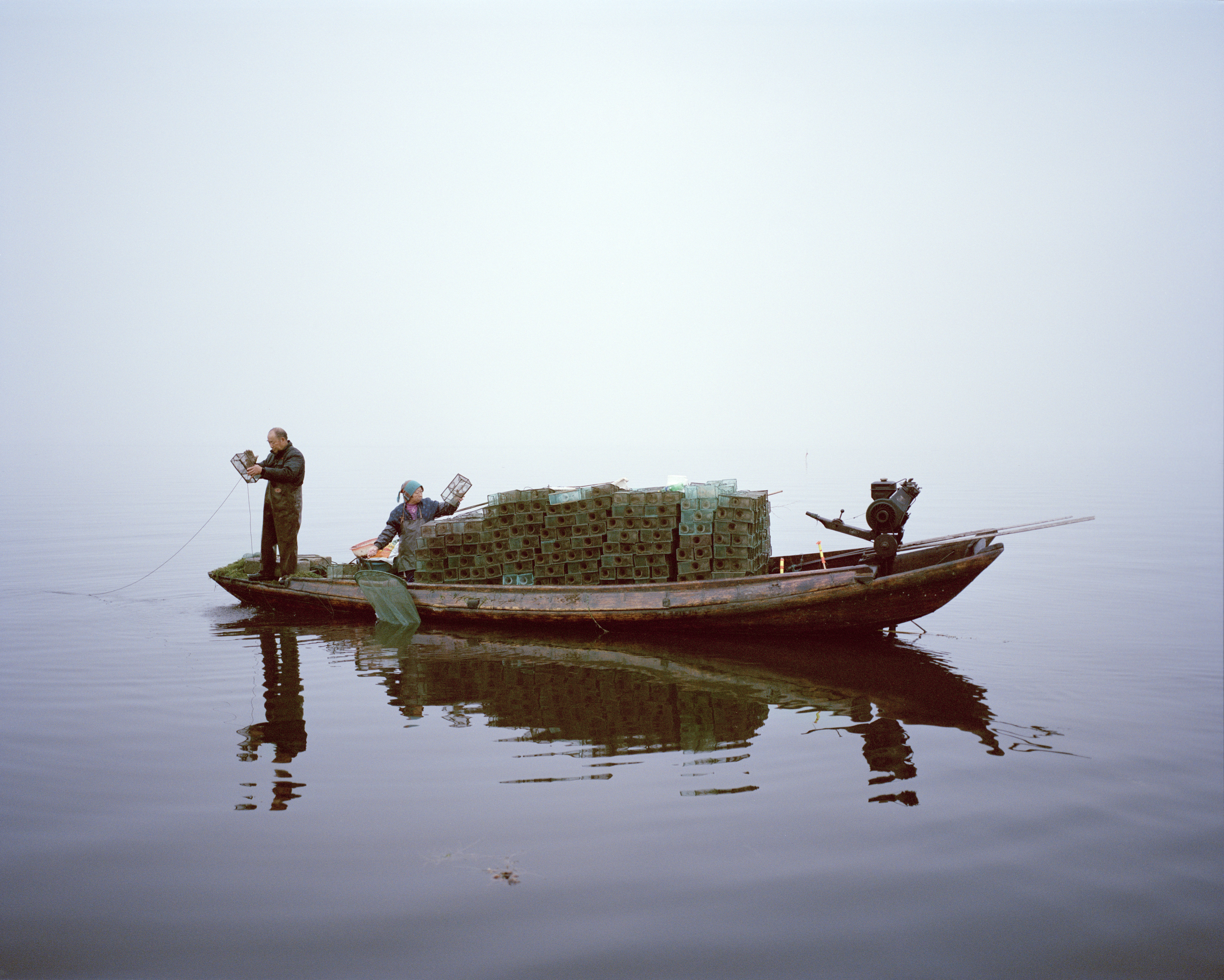 Shrimp fishing, Lake Hong, Hubei Province, China, 2015. A couple work on the lake at sunrise. Although poems and stories about Lake Hong’s purity are enshrined in Chinese cultural history, it has been damaged by unsustainable fishing practices. Over the past 14 years local communities and government have helped to restore the lake, demonstrating how sustainable fishing methods can result in healthy fish, reduced pollution and clean water. Credit: © Mustafah Abdulaziz / WWF-UK