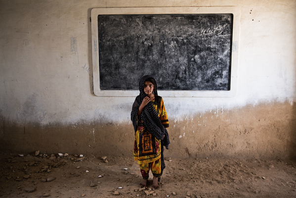 Six-year-old Gul stands amid the ruins of her classroom in Haji Karfoor Jat. The school’s walls and ceiling are collapsing due to erosion by saline groundwater and salt winds blowing from the nearby Arabian Sea.