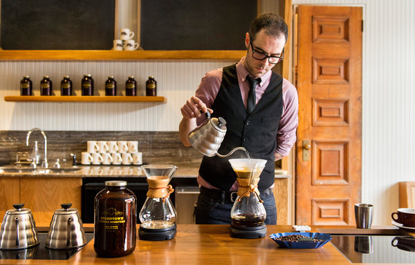 A hipster barista makes a potent brew.