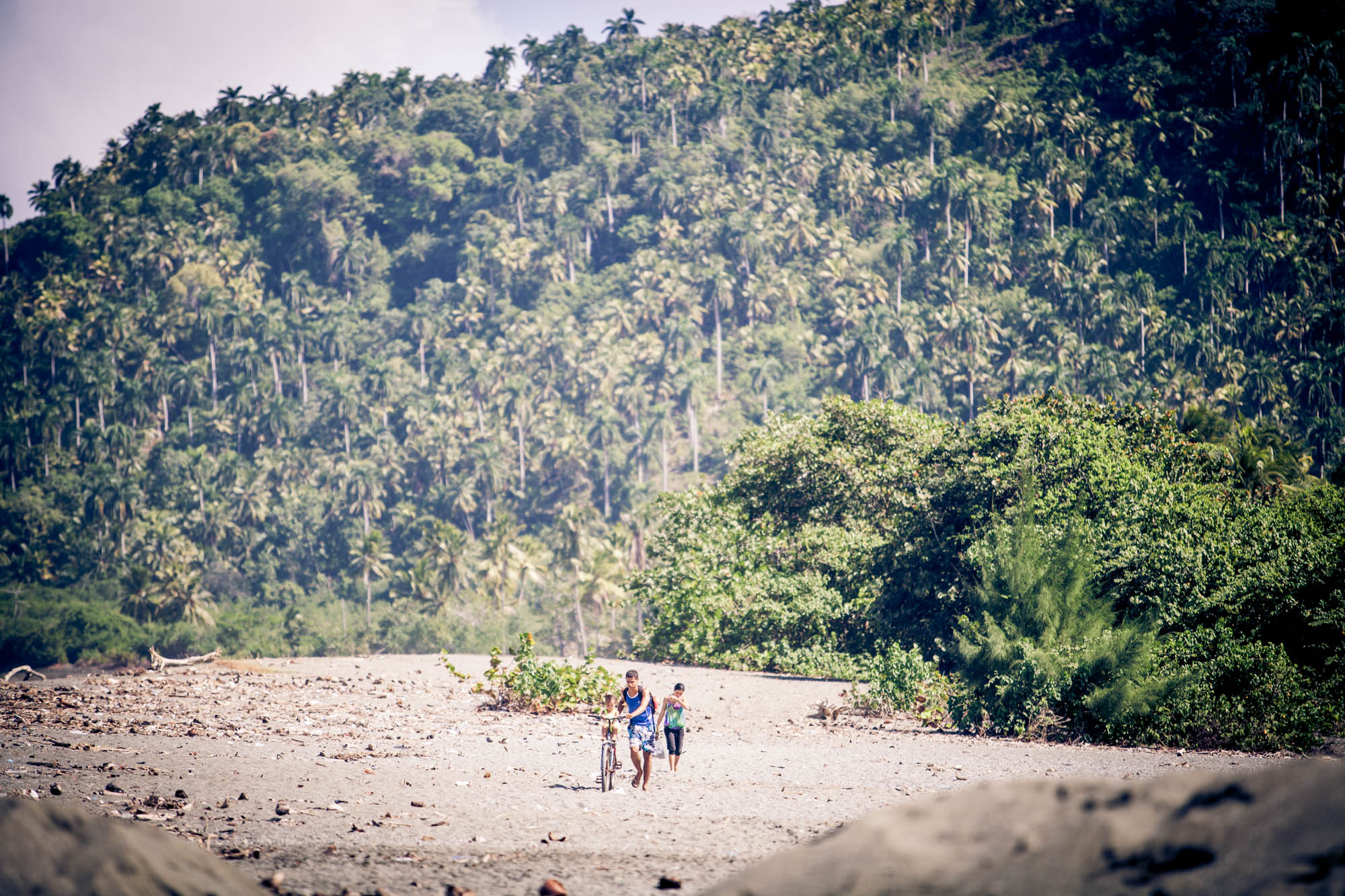 BEACH WALK A family walks back toward town from the beach. Baracoa, Cuba.