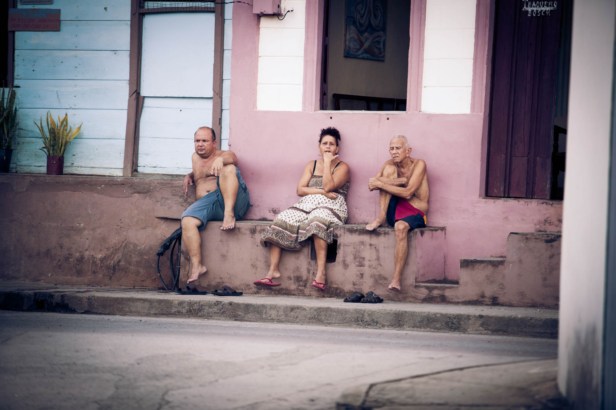 STREET SCENE A typical street scene in Baracoa. People would congregate outside of homes chatting and catching up. The pace of life was far slower than what we're used to.