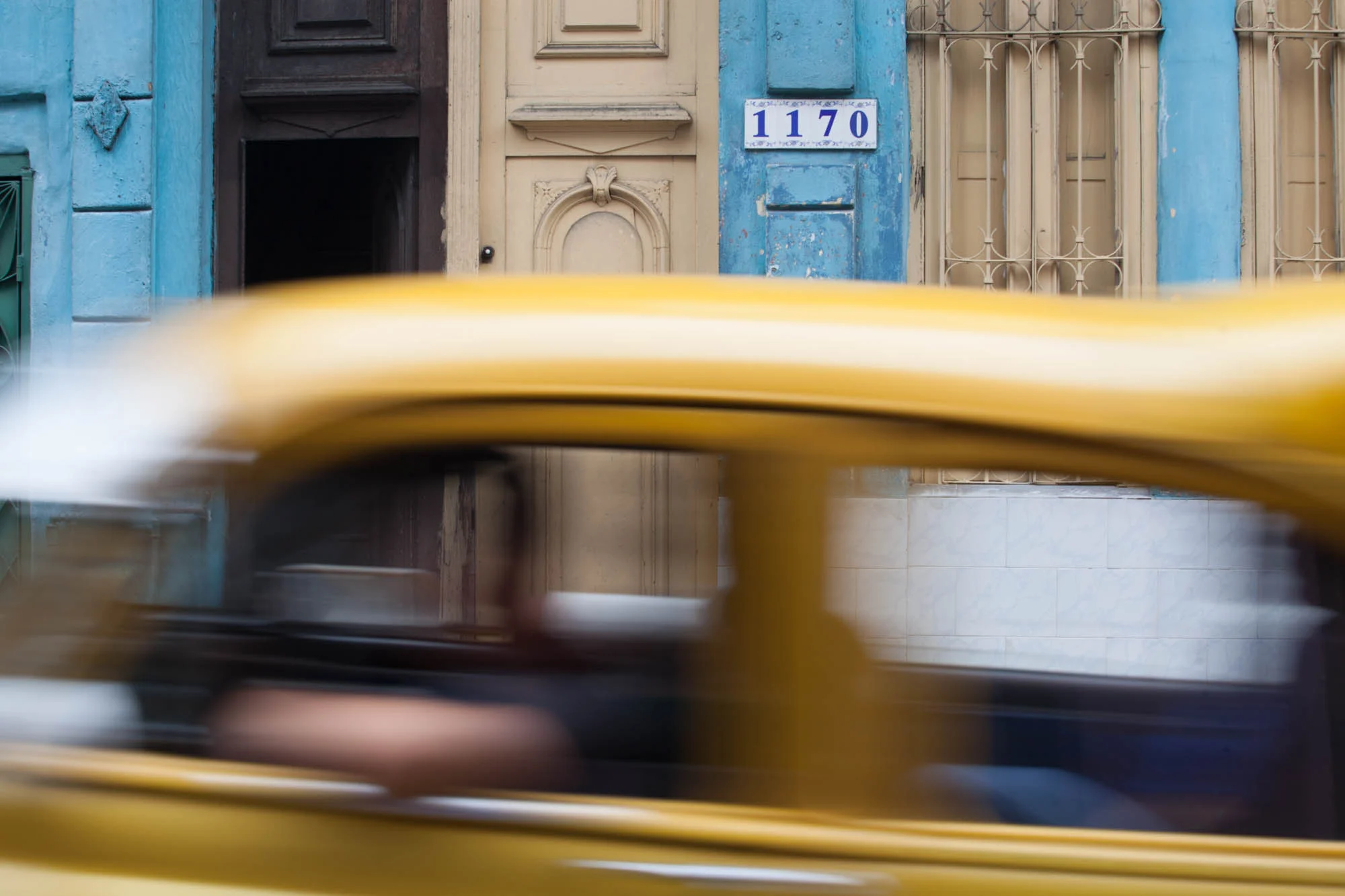 RIPPING BY A classic car rips by on the streets of Havana.