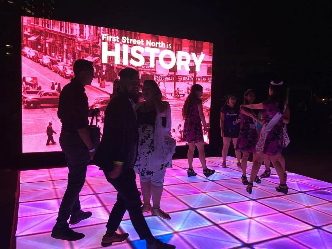 Festival goers on the interactive dance floor on First Street North © Maya Santos