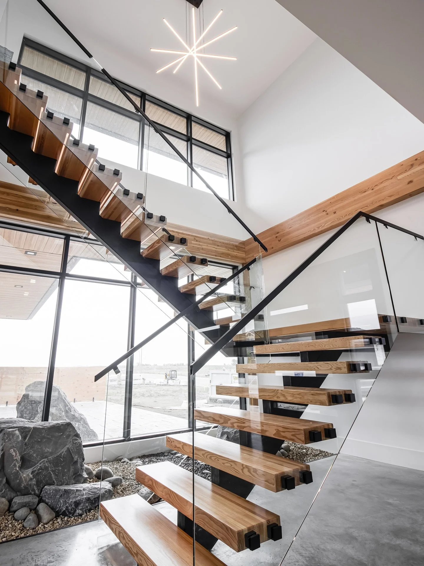 A staircase should do more than connect floors &mdash; it should make a statement. This floating staircase and sculptural lighting became the true centrepiece of this build, setting the tone for the entire home. 

#MathewsDesignCo #StatementStaircase