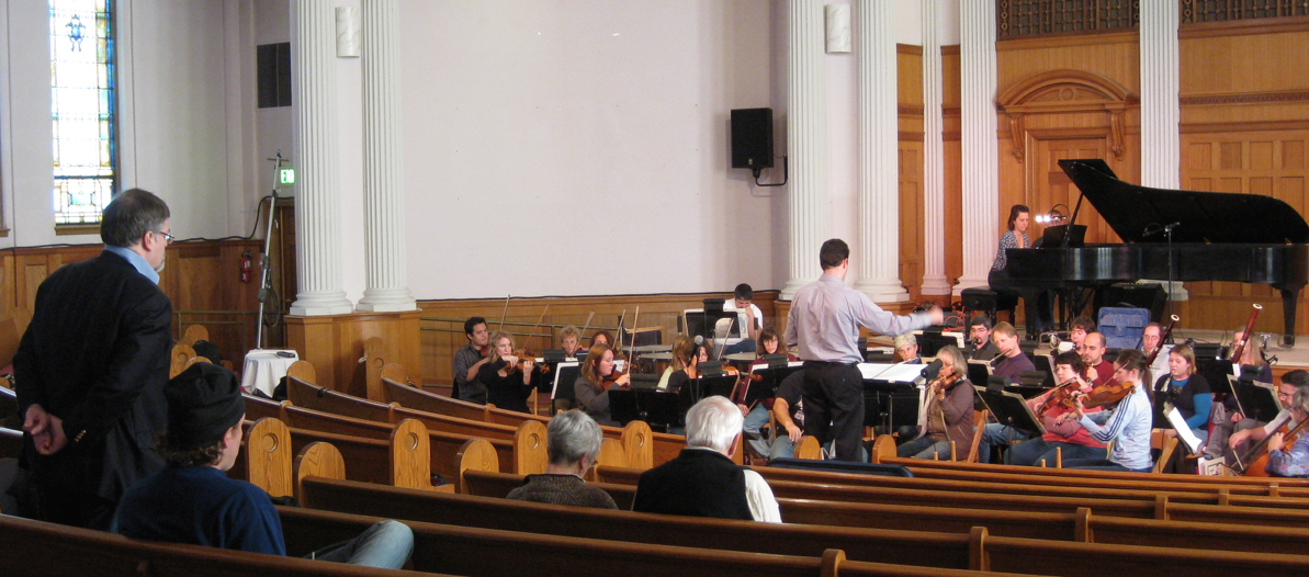 Hagen looks on as Lawrence Golan rehearses the Yakima Symphony, Tanya Stambuk soloist, in the Piano Concerto.
