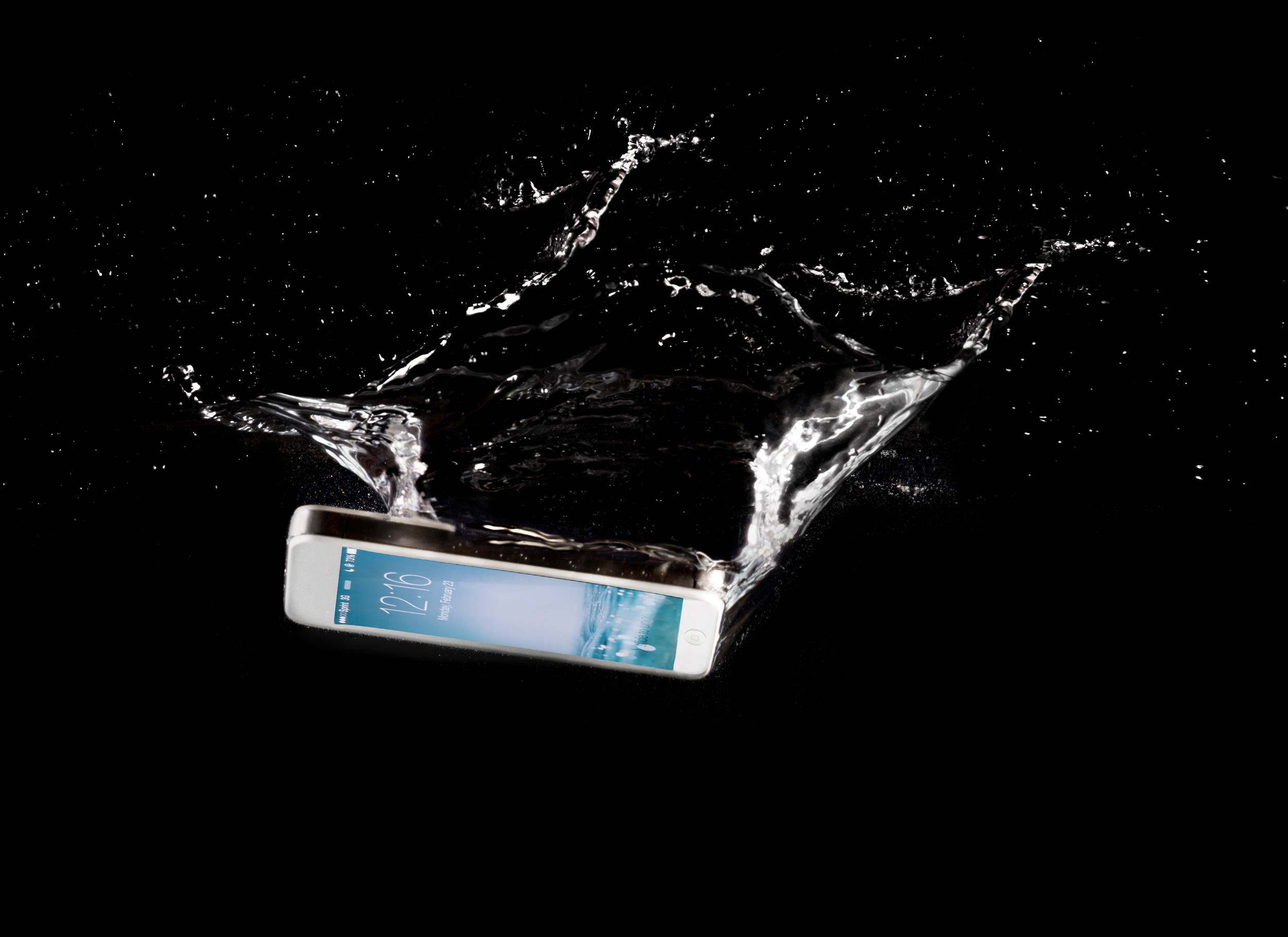 Commercial photo of an Iphone splashing into water with the screen on in a black background.Utah Copyright 2016 InTheLoupePhotography