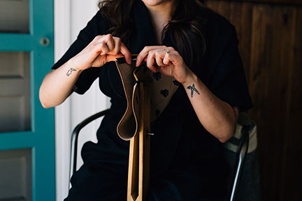 Megan saddle stitching a leather bag l in the Stitch &amp; Shutter Studio