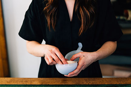 Megan wet molding and forming a leather bowl in the Stitch &amp; Shutter Studio 