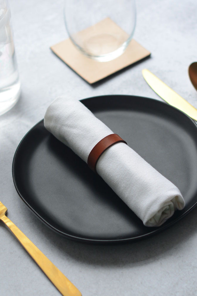 square natural leather coaster on table