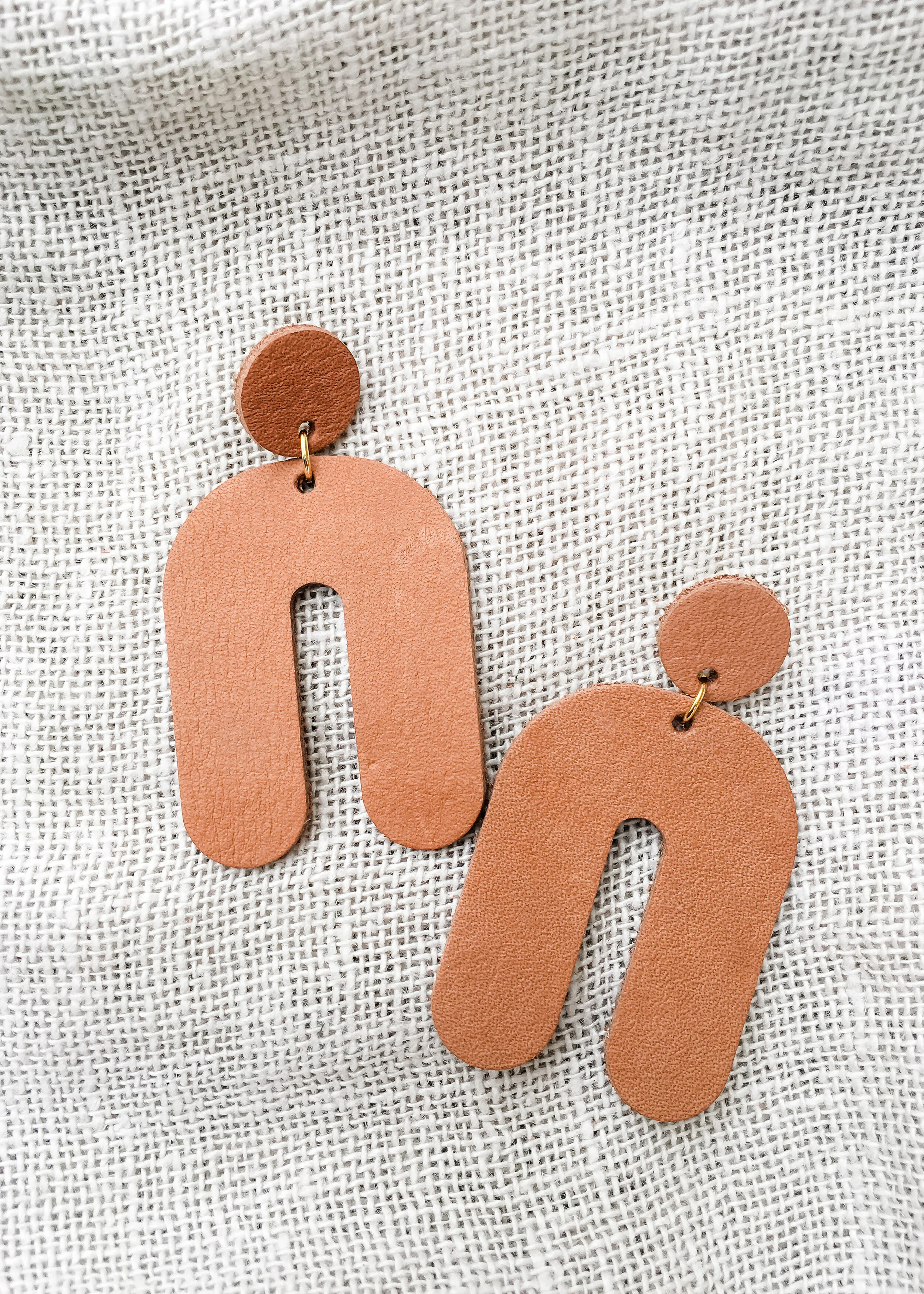 arch drop earrings tan